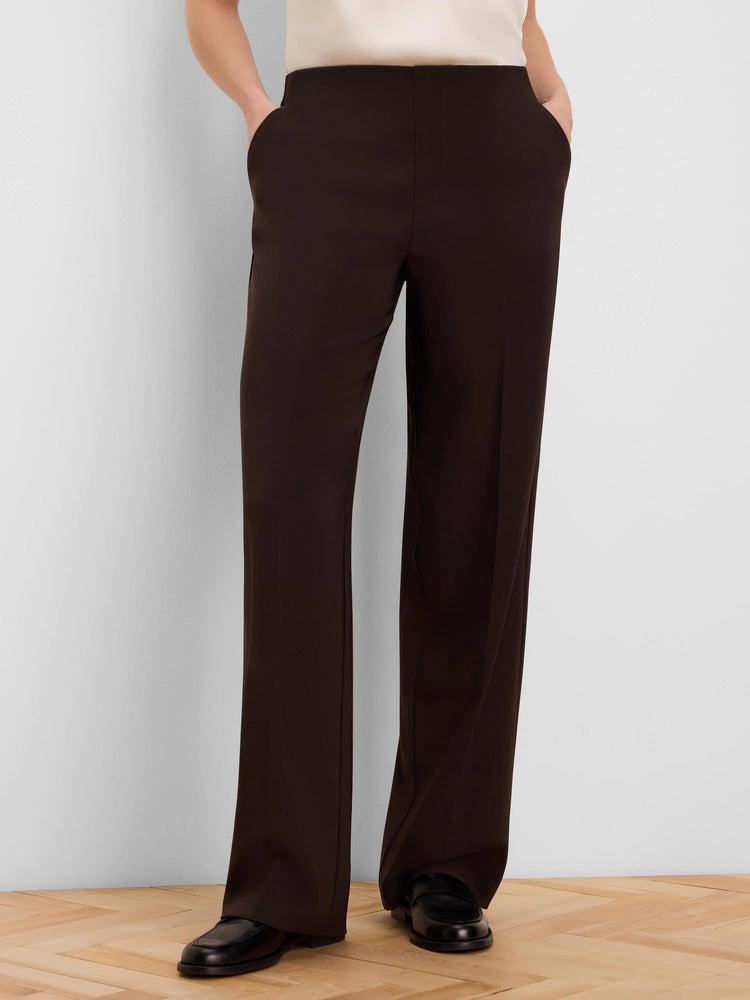 Dark brown wide-leg pants, full length. Features a smooth, flat waistband, subtle side pockets, and a clean drape.