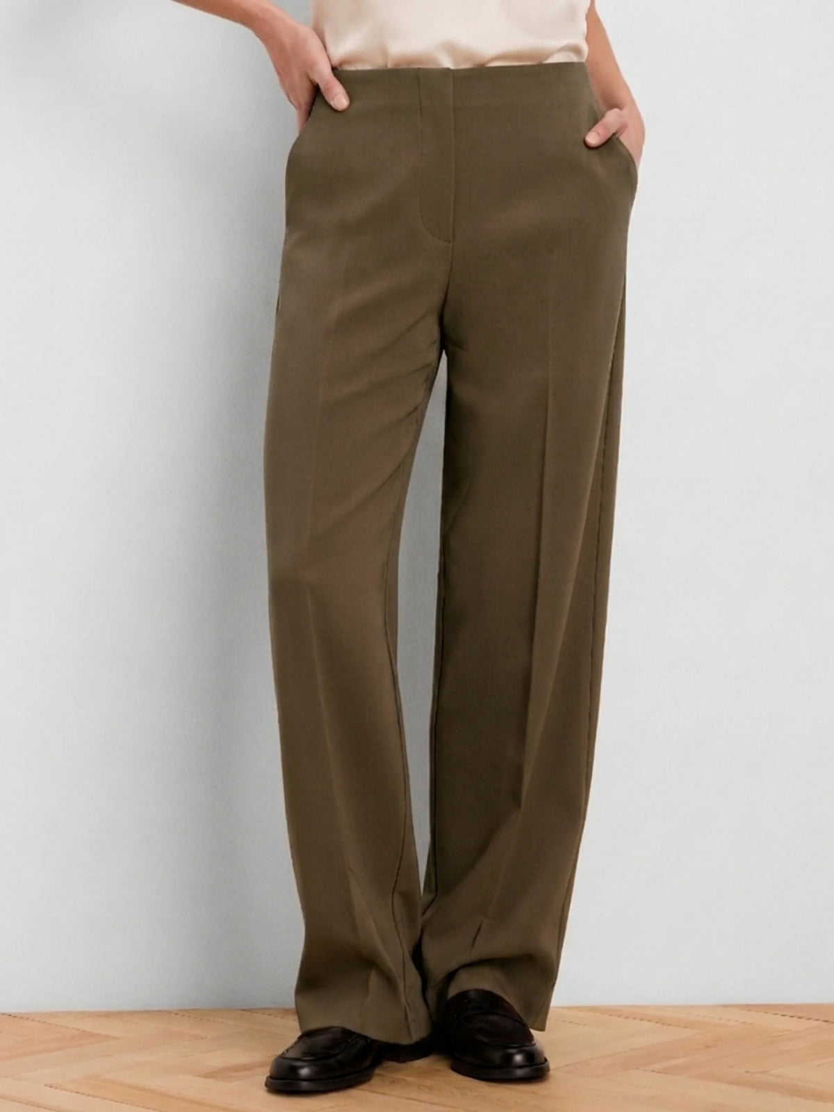 Olive wide-leg pants with a smooth finish, high waist, flat front, and side pockets.