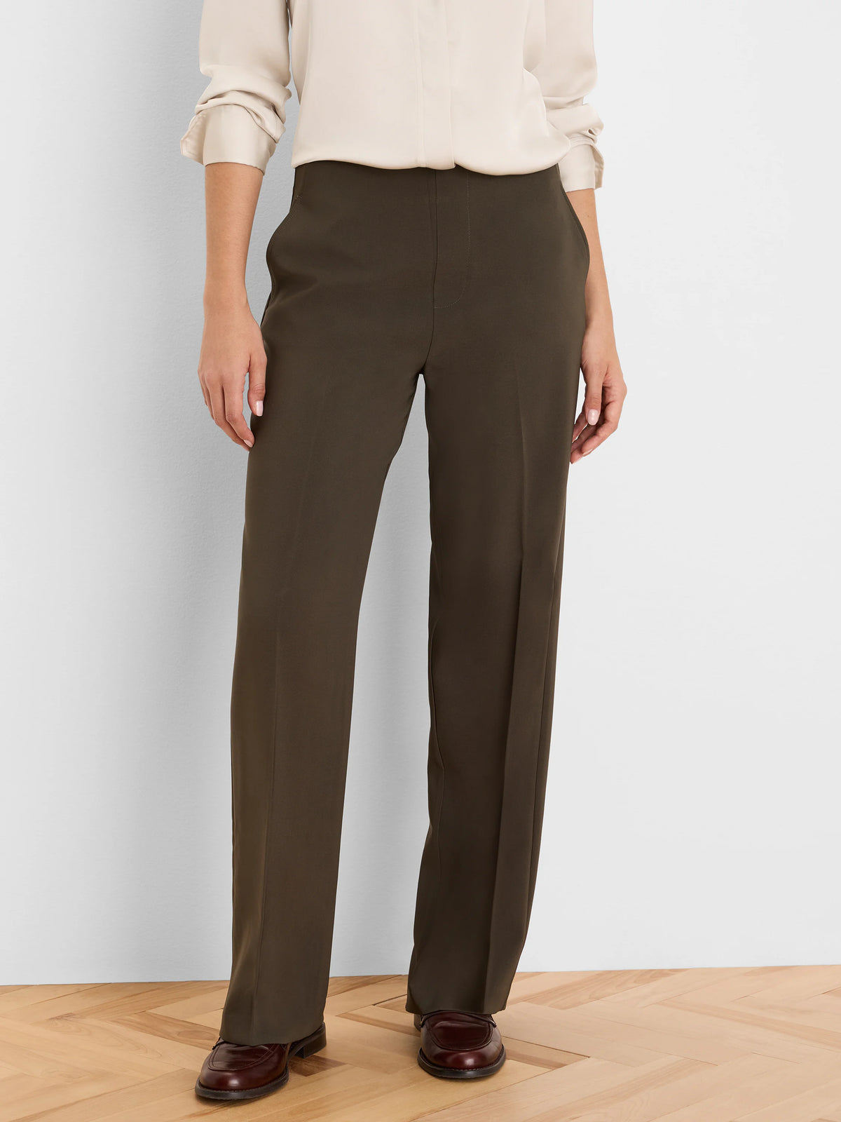 Dark olive wide leg pants, full-length with a smooth fabric and a subtle front crease.