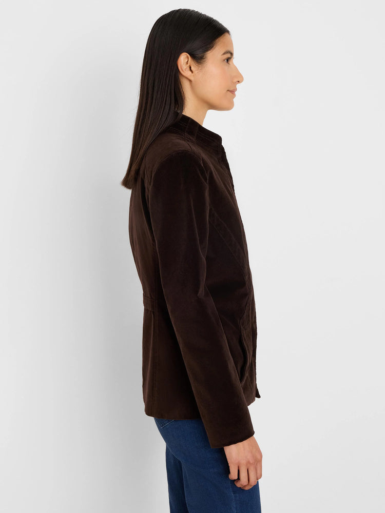 Dark brown stretch velvet riding jacket with stand collar, cinched waist, and quilted shoulder details.