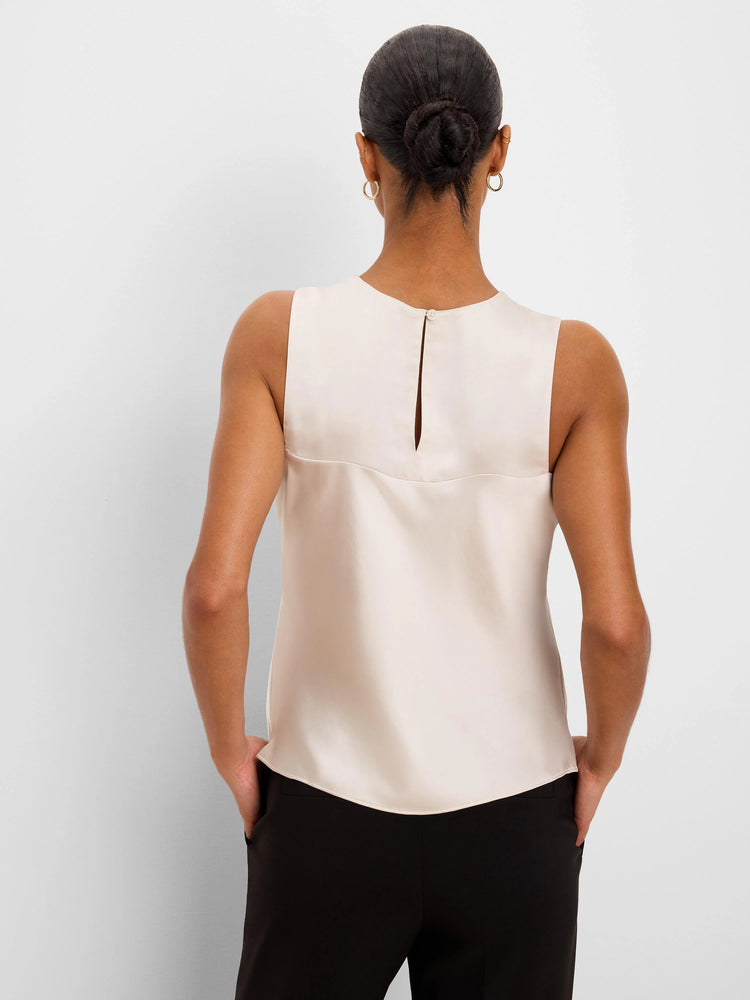 Back view of a sleeveless, light cream glossy tank top with a keyhole button closure at the neck and a horizontal upper...