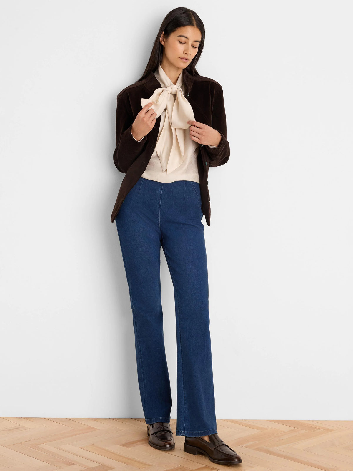 Cream crinkled top with a large, soft fabric bow tied at the neck.