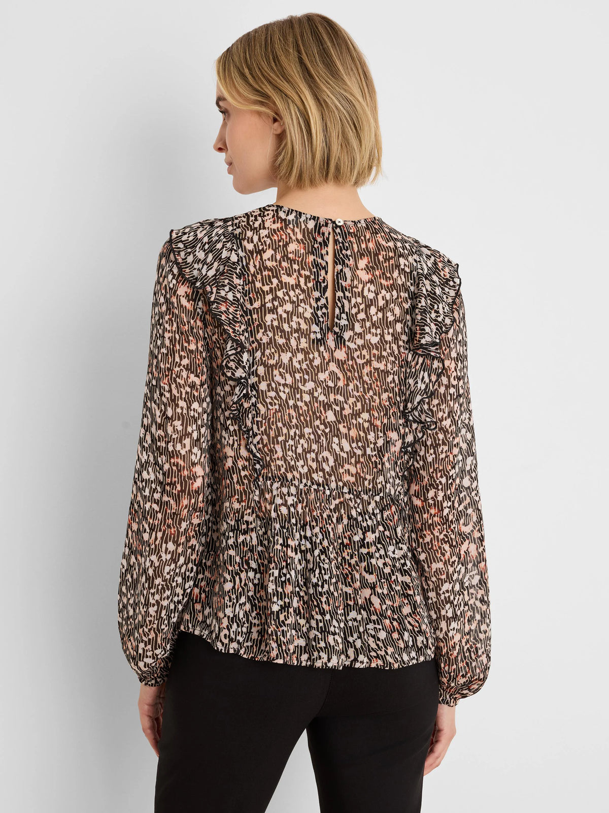 Sheer black, beige, and peach animal print shirt with ruffled shoulders, long gathered sleeves, and keyhole back.