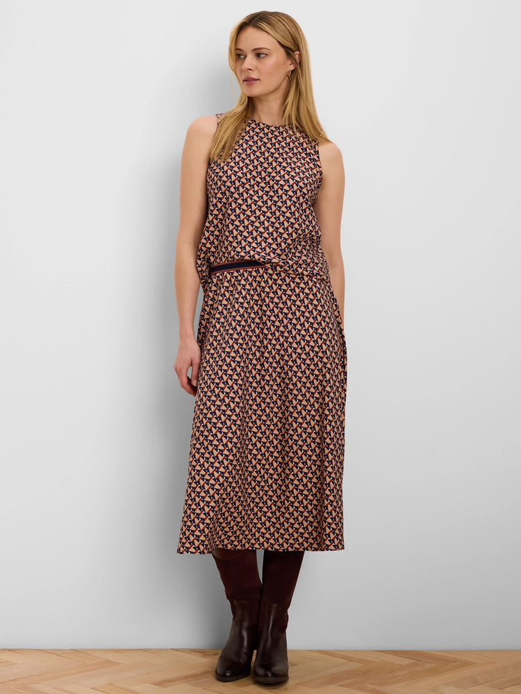 Sleeveless top with a geometric pattern of dark blue, rust, and beige interlocking shapes.