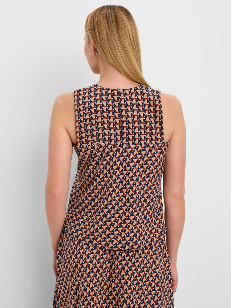 Sleeveless top, back view. Tan, navy, and reddish-brown geometric tile pattern. Round neck with back button closure.
