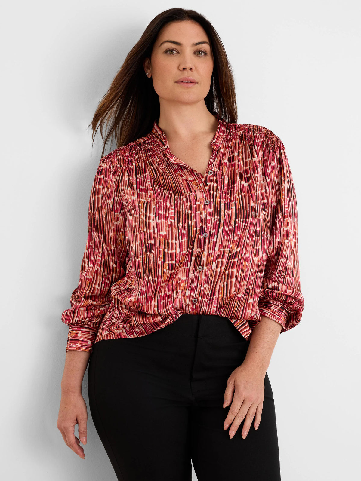 Origami Pleat Shirt: Red, pink, orange, black abstract print with fine vertical pleats, band collar, and gathered cuffs.