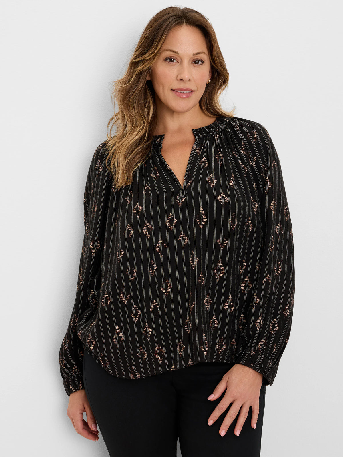 Black Lurex shirt with thin silver vertical stripes and scattered rose gold metallic diamond patterns. V-neck, long sleeves.