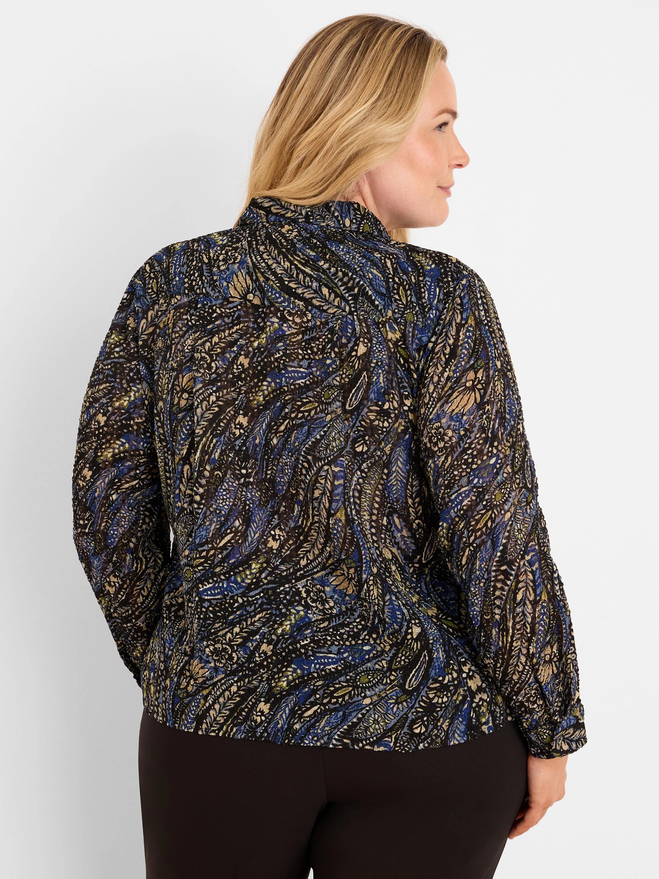 Dark crinkled chiffon shirt with blue, beige, & olive paisley pattern. Long sleeves, high collar. Model's back shown.