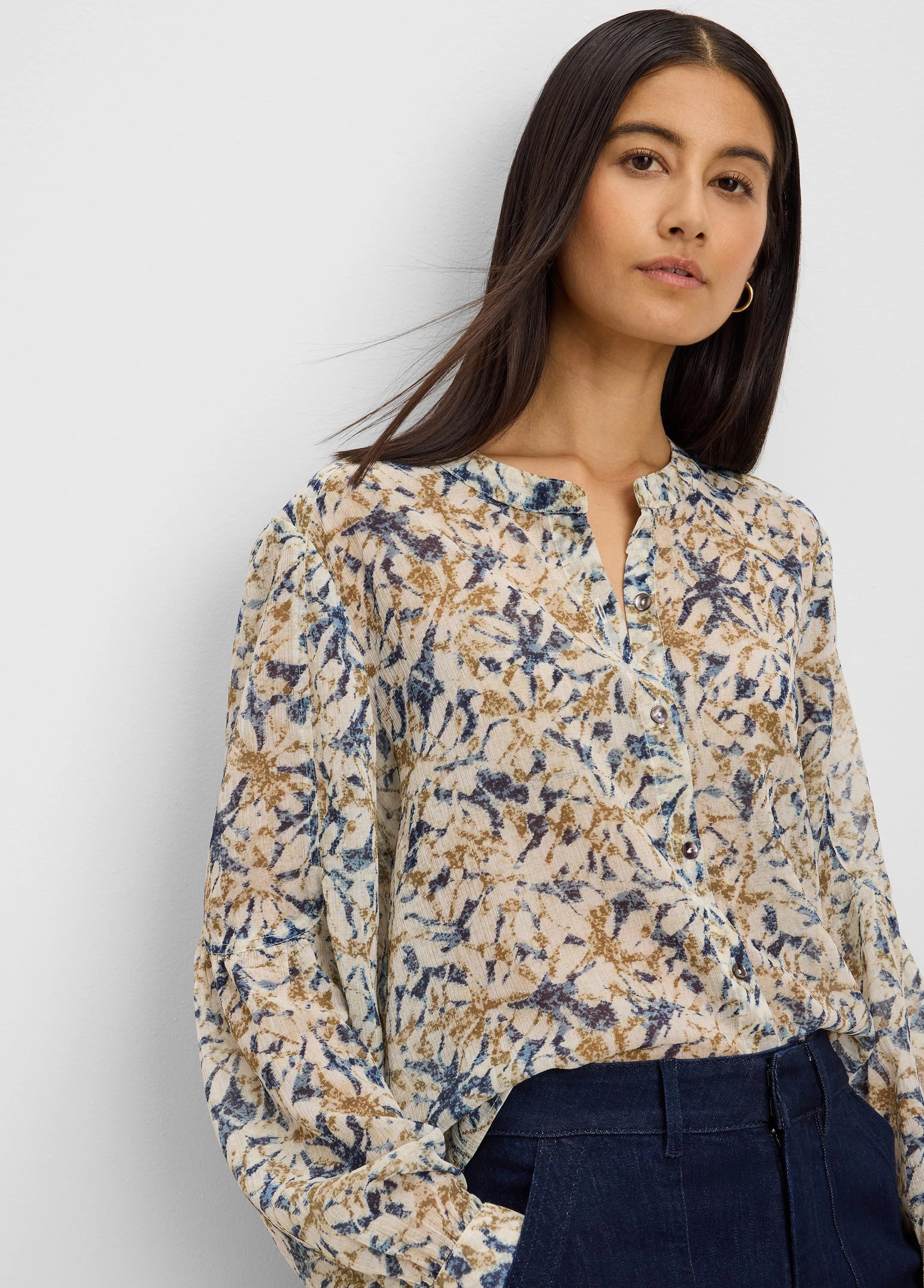 Cream chiffon shirt with abstract navy and golden brown print, long sleeves, and a band collar.