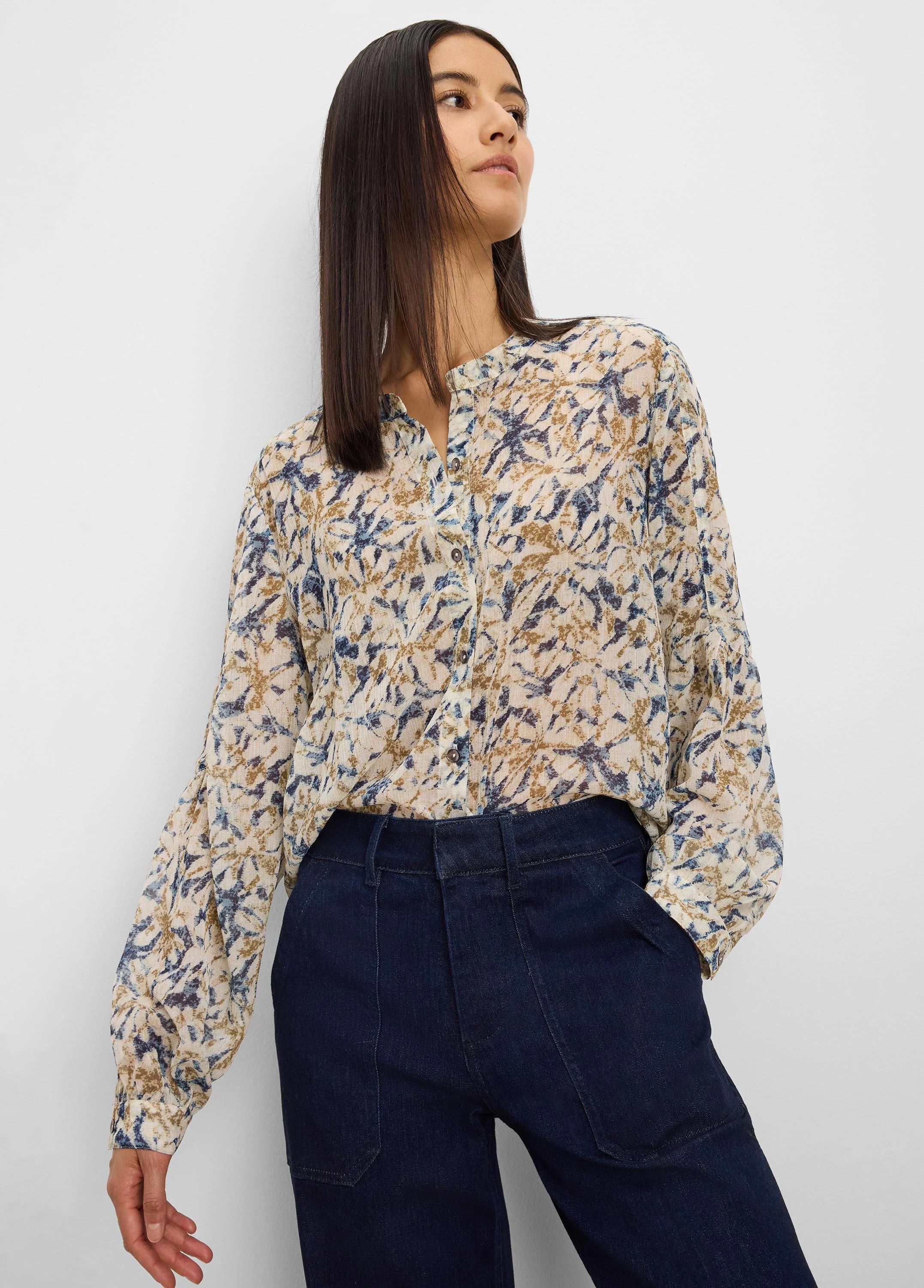 Cream chiffon shirt with abstract blue and brown pattern, band collar, long cuffed sleeves.
