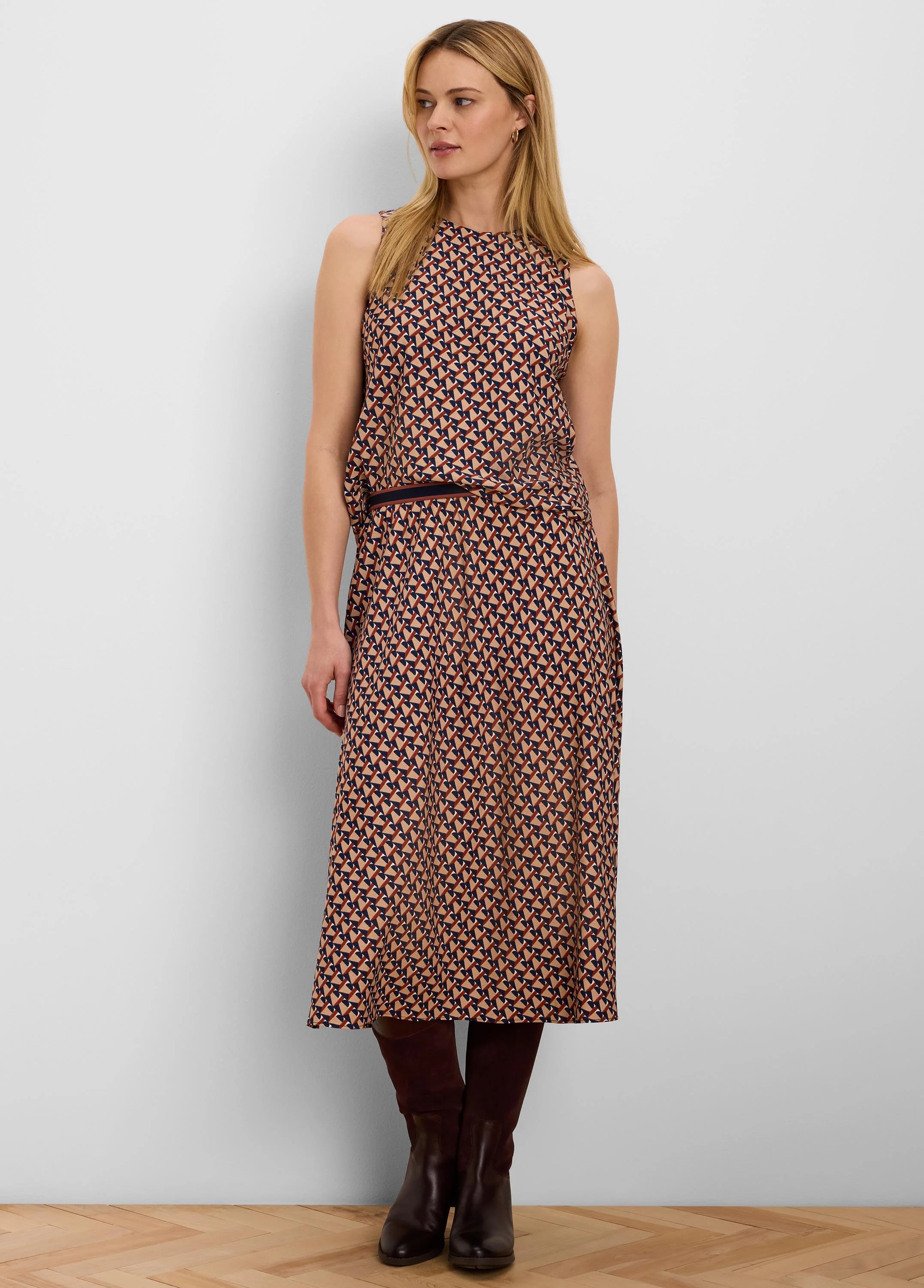 Midi skirt with tan, navy, rust & white geometric tile pattern. Dark blue elastic waistband.