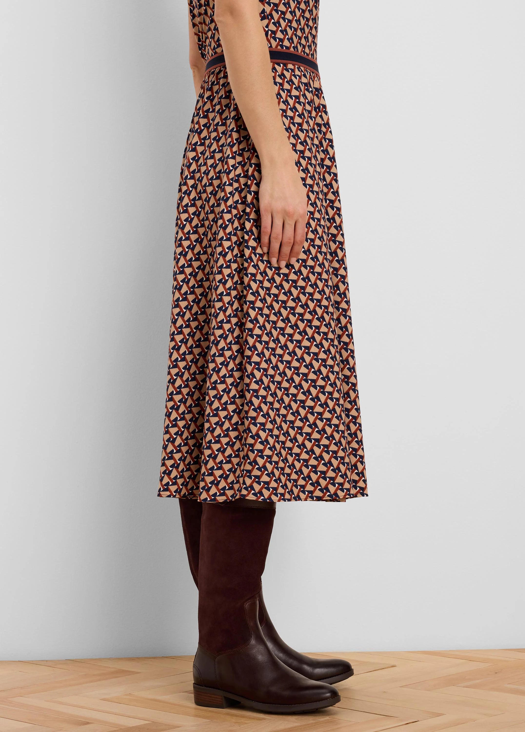Midi skirt with tan, dark brown, and navy blue geometric tile pattern & striped waist.