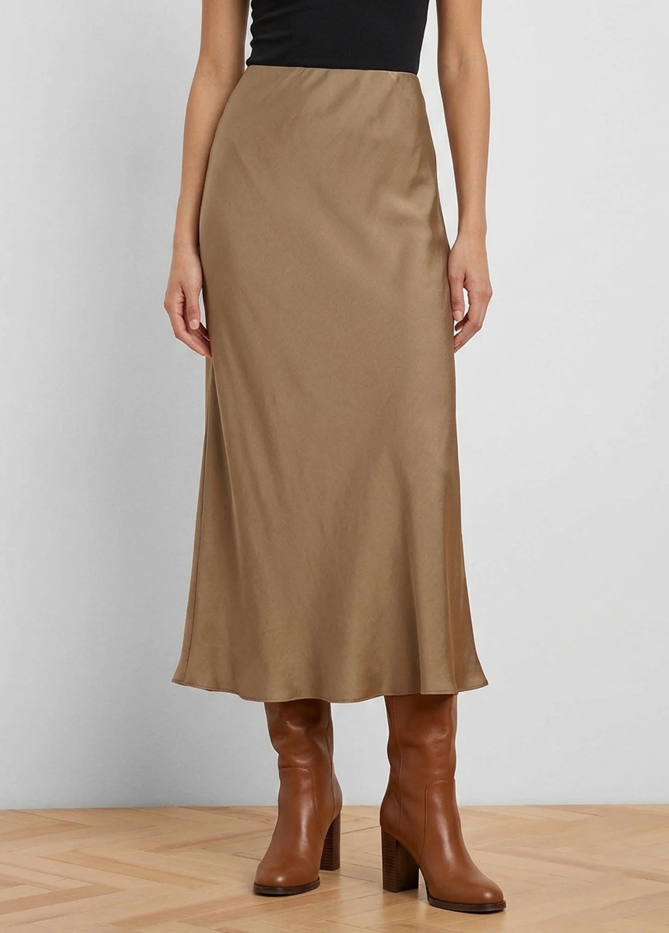 Tan glossy midi slip skirt, softly draped.
