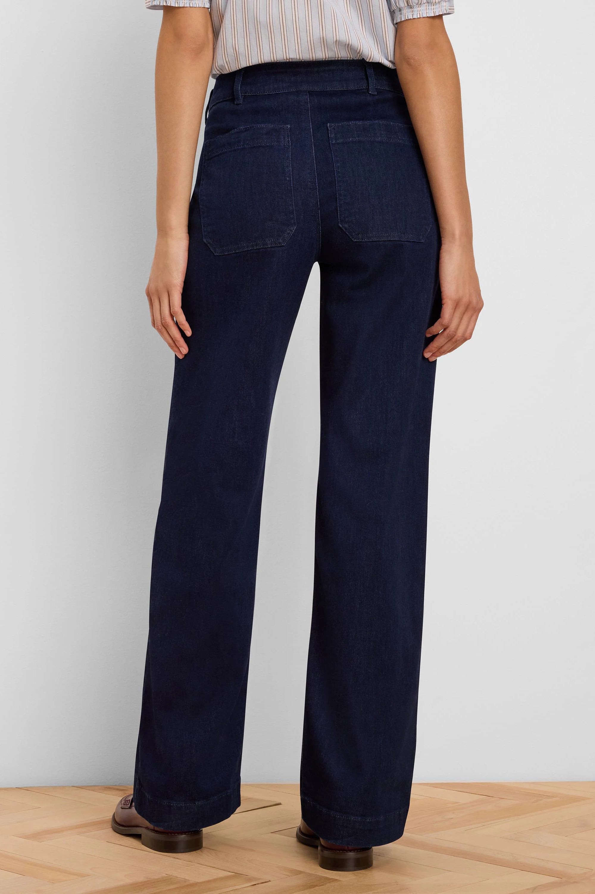 Dark blue wide leg jeans, shown from back, with two rectangular patch pockets on the rear.