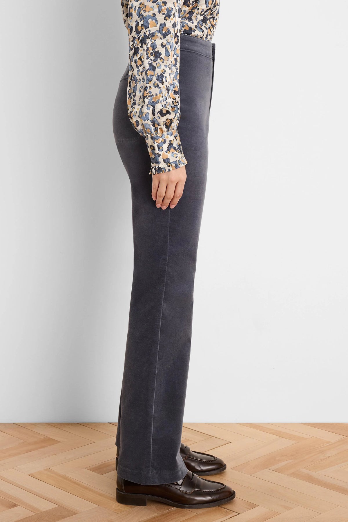 Dark grey velvet high-rise bootcut pants, shown from the side on a model.