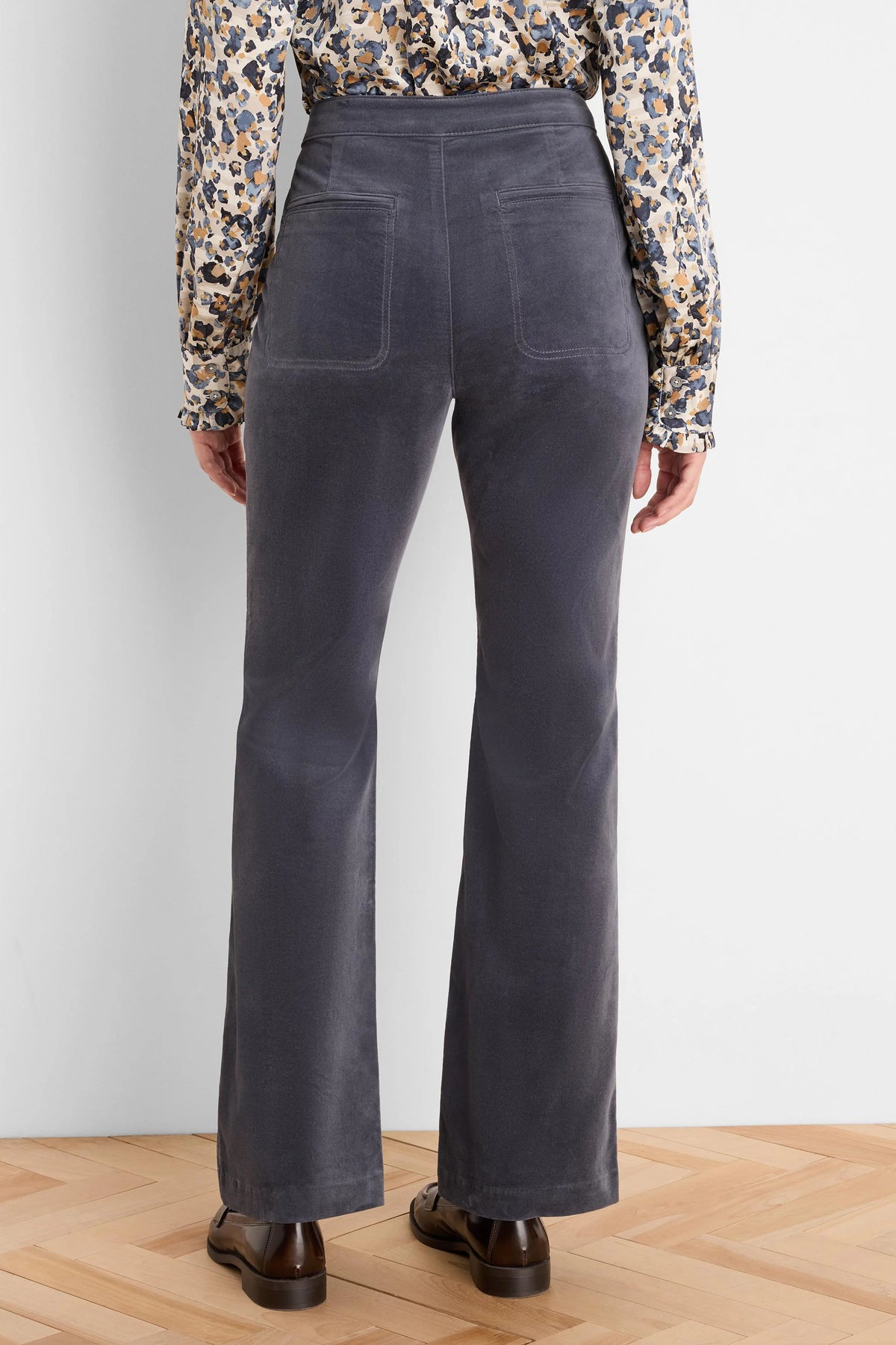 Charcoal grey velvet high-rise bootcut pants with two back patch pockets.