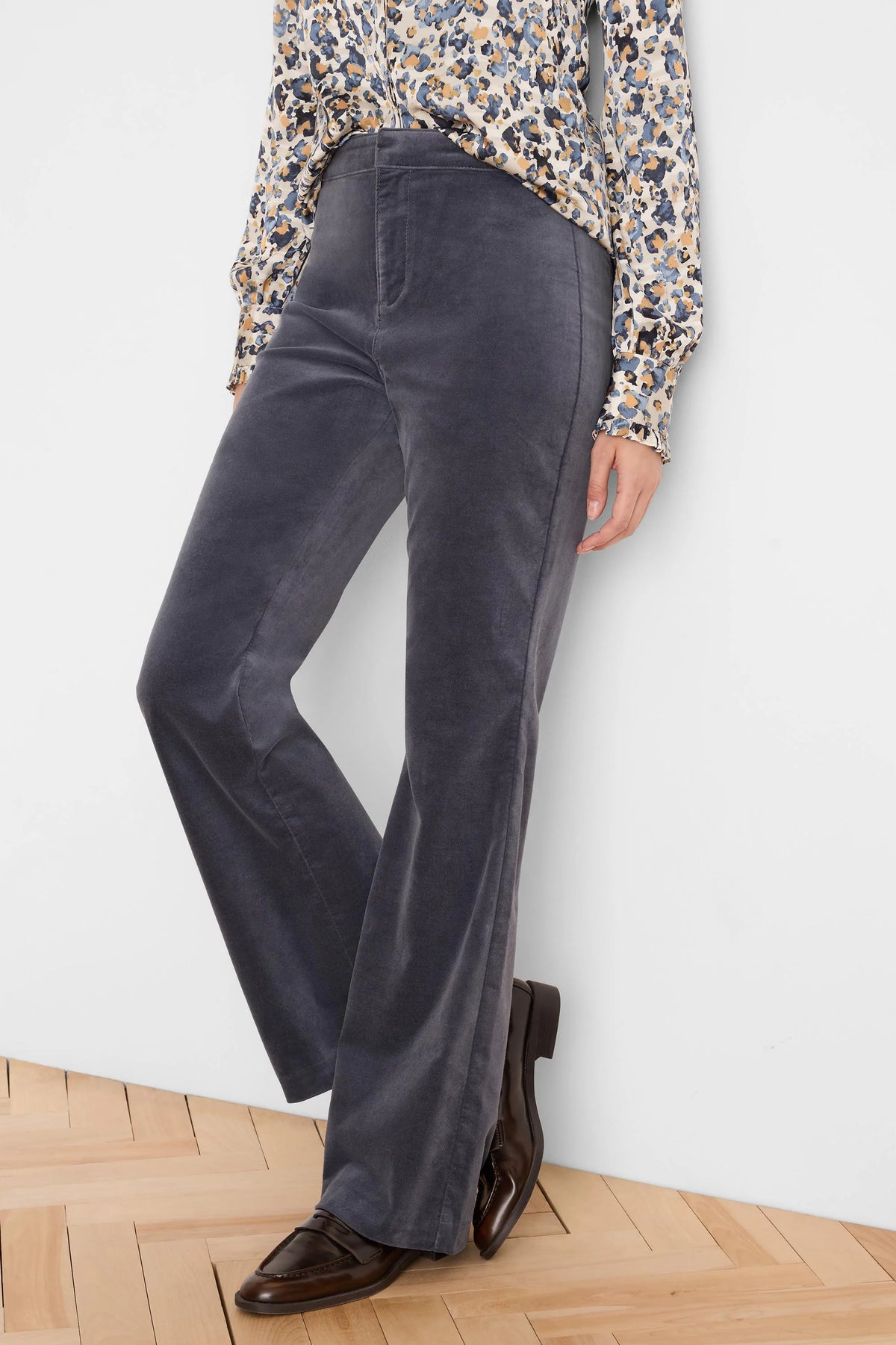 Charcoal high-rise velvet boot-cut pants, shown worn, flared hem covering shoes.