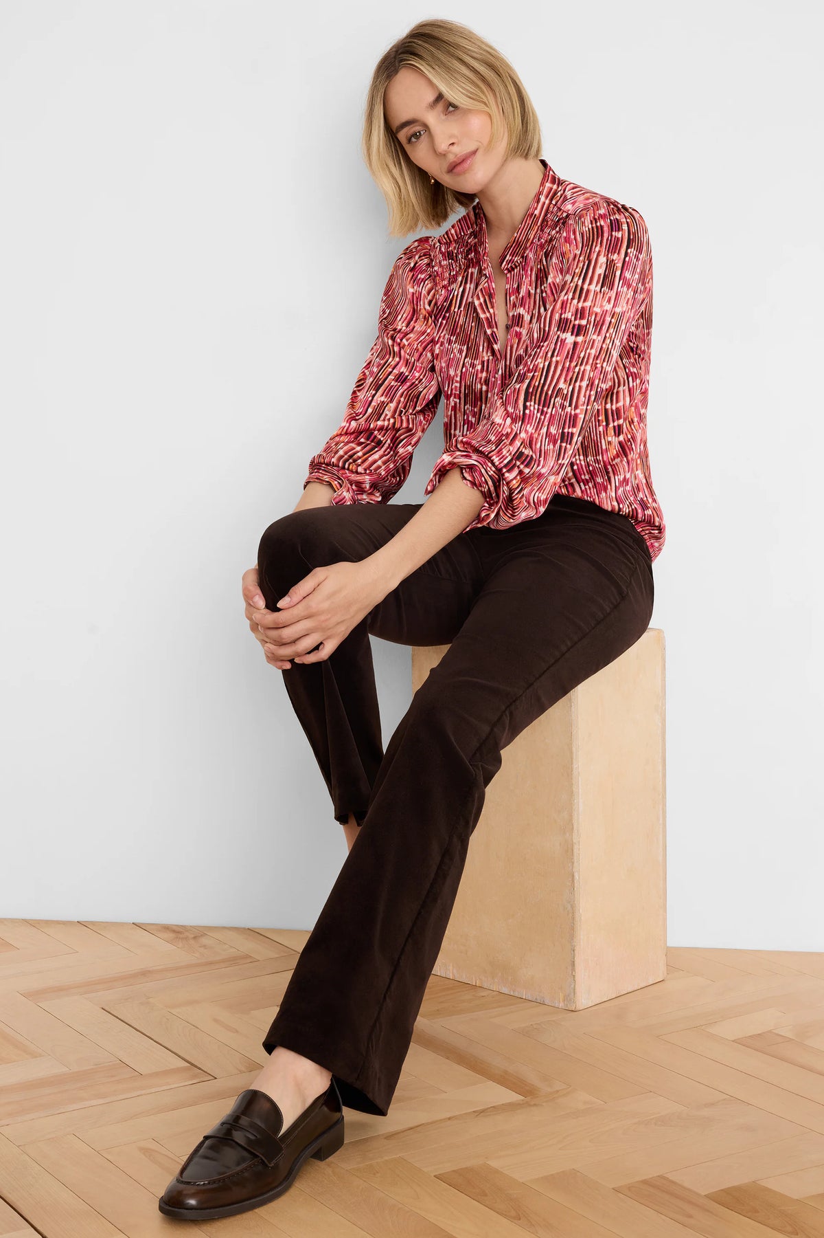 Deep brown high-rise stretch velvet boot cut pants.