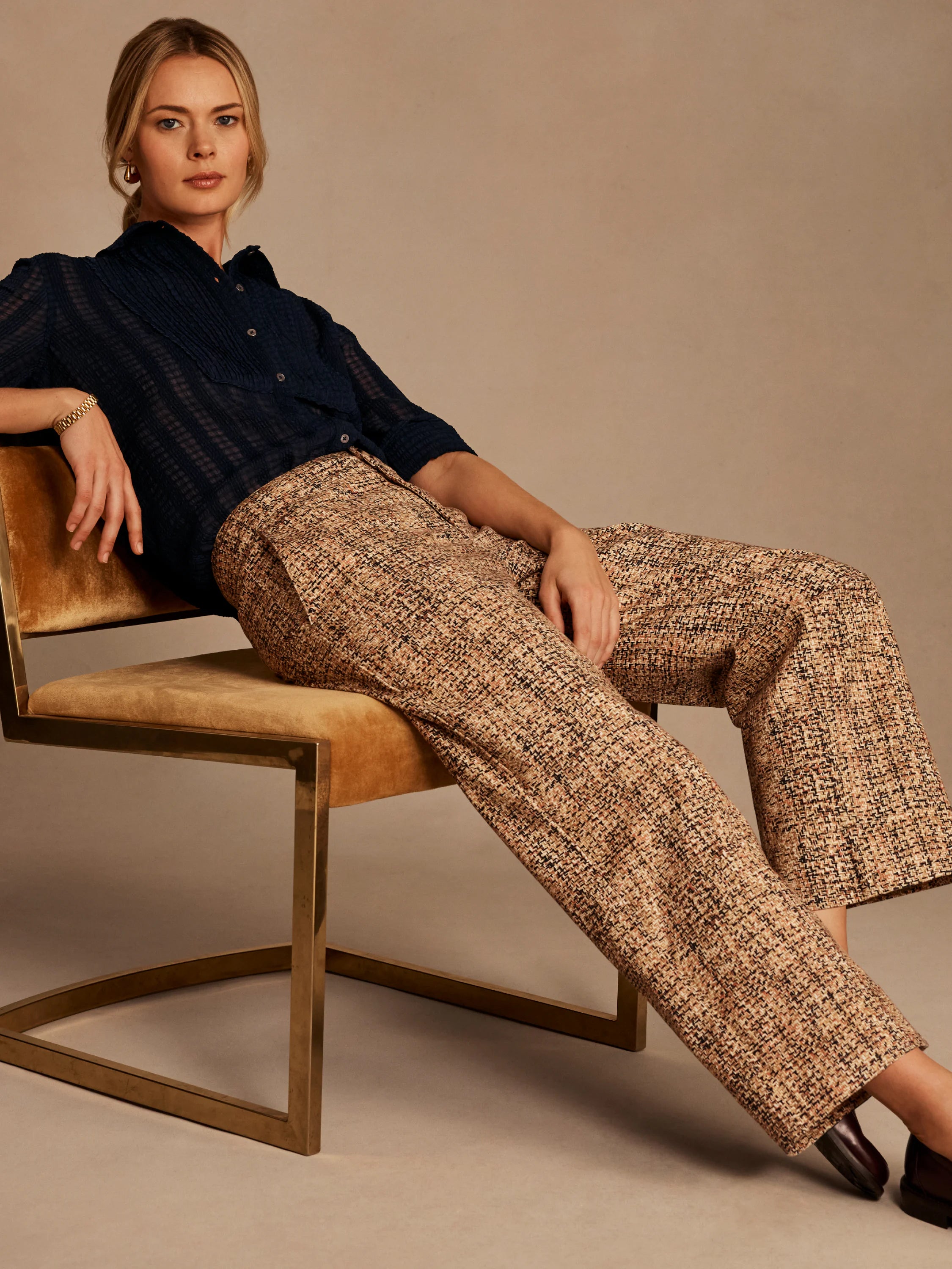 Beige, brown, black tweed cuffed ankle pants with a wide-leg cut.