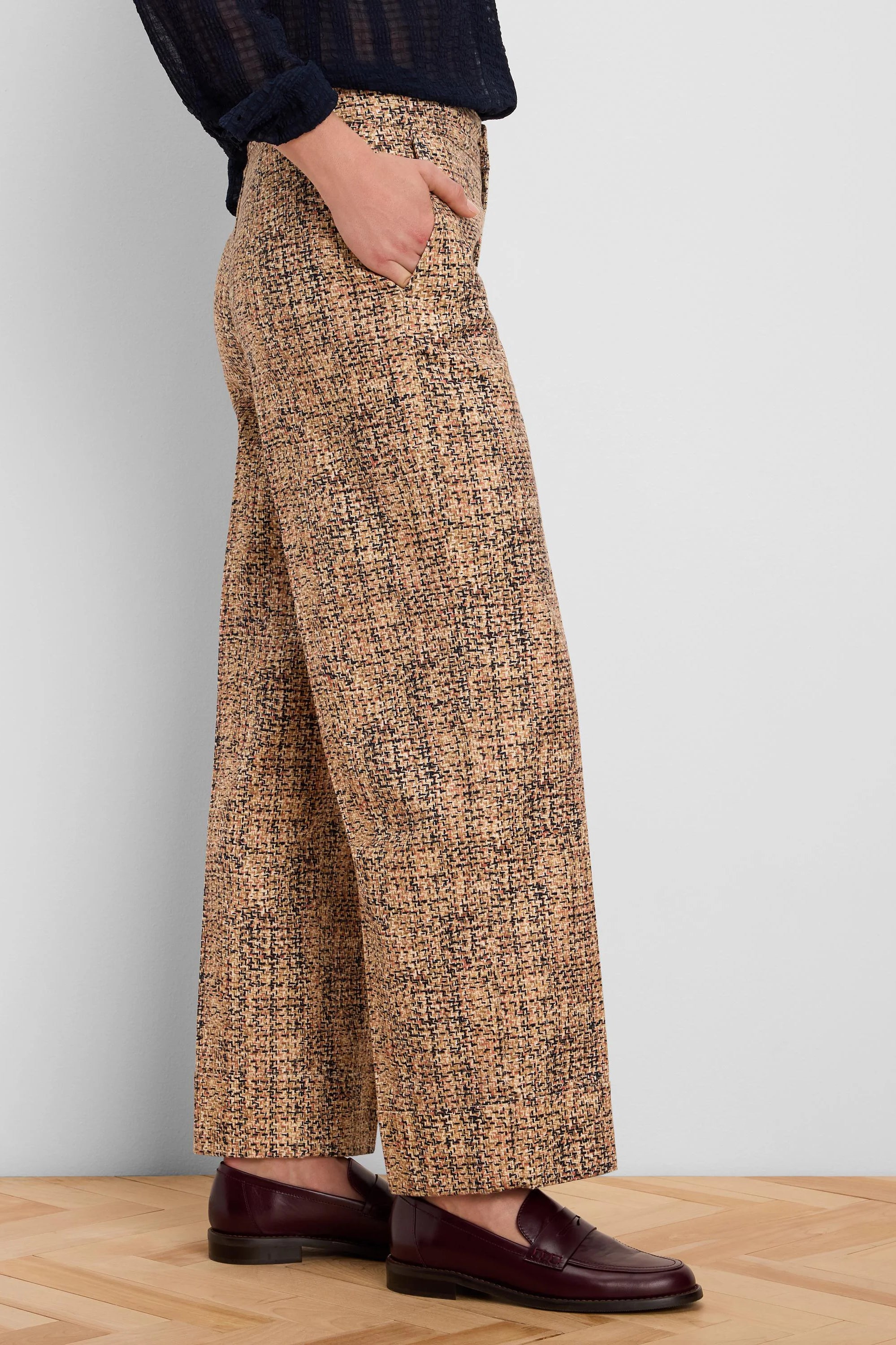 Light brown tweed wide-leg ankle pants with cuffs. Fabric shows black and subtle reddish flecks in the pattern.