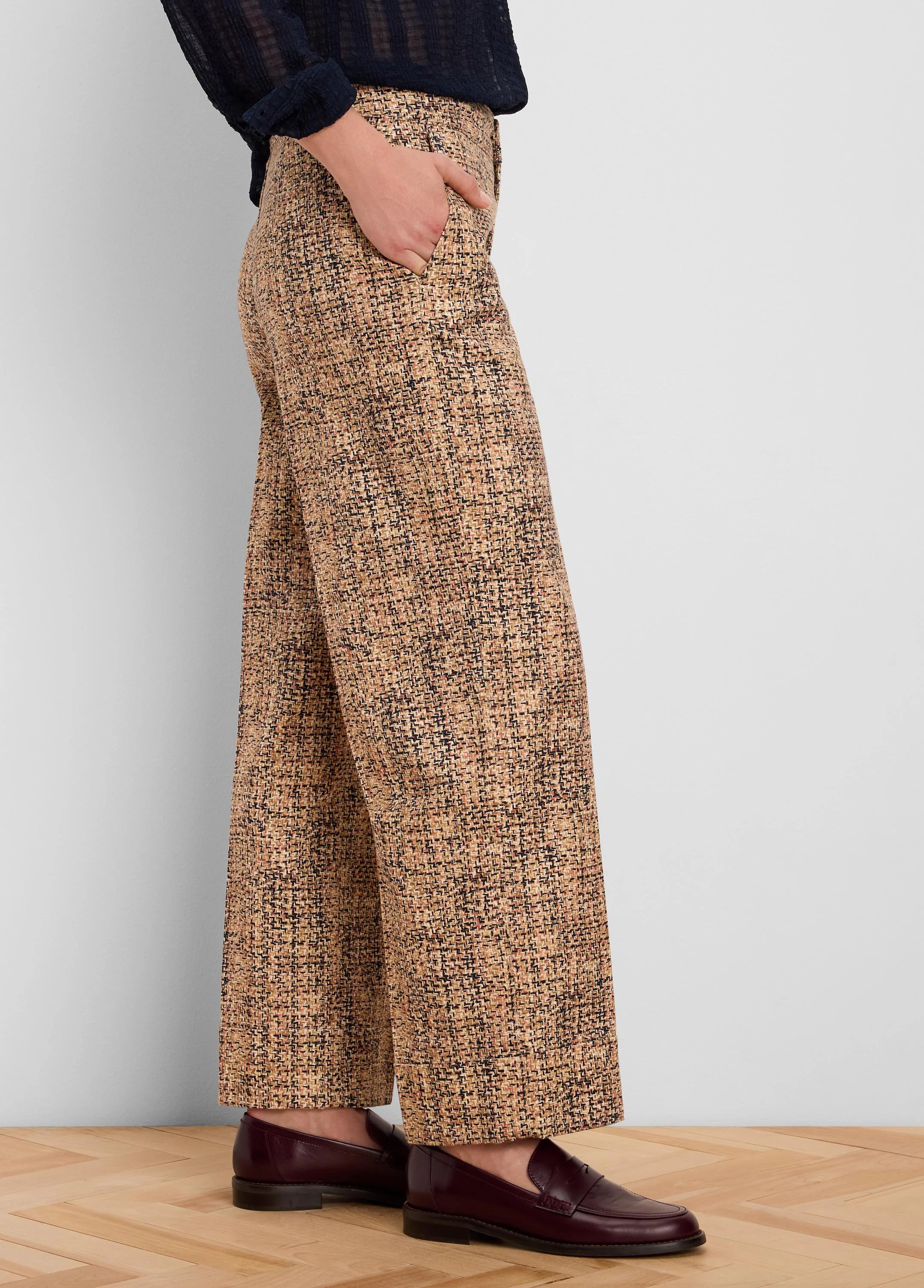 Light brown tweed wide-leg ankle pants with cuffs. Fabric shows black and subtle reddish flecks in the pattern.