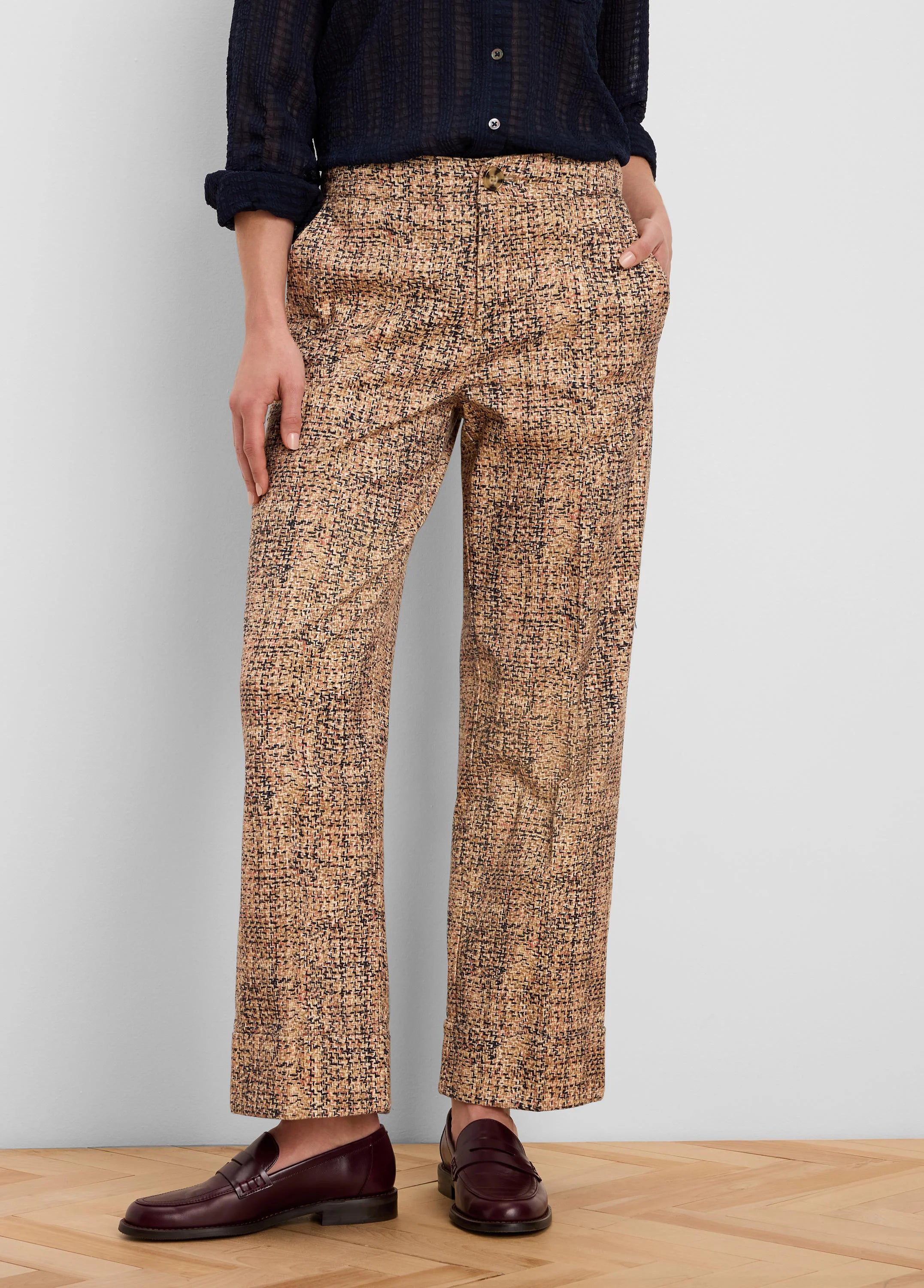 Tan, black, and brown printed tweed ankle pants with cuffed hems and a button closure.