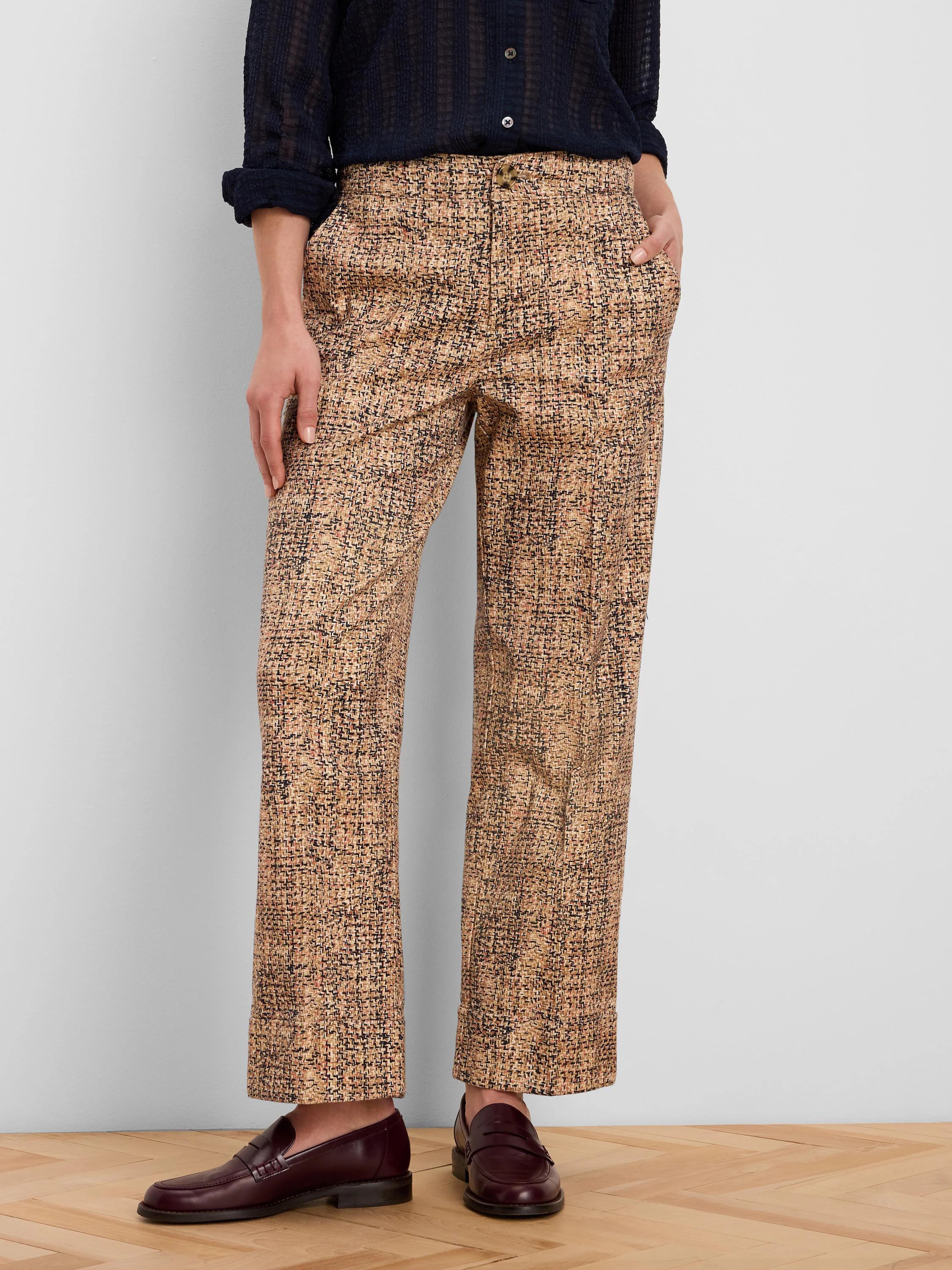 Tan, black, and brown printed tweed ankle pants with cuffed hems and a button closure.