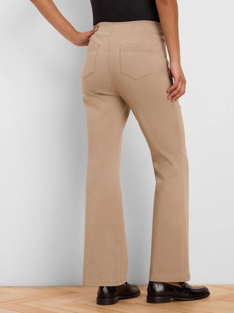 Tan bootcut pants, high-waisted with rear patch pockets, shown from behind on a model.