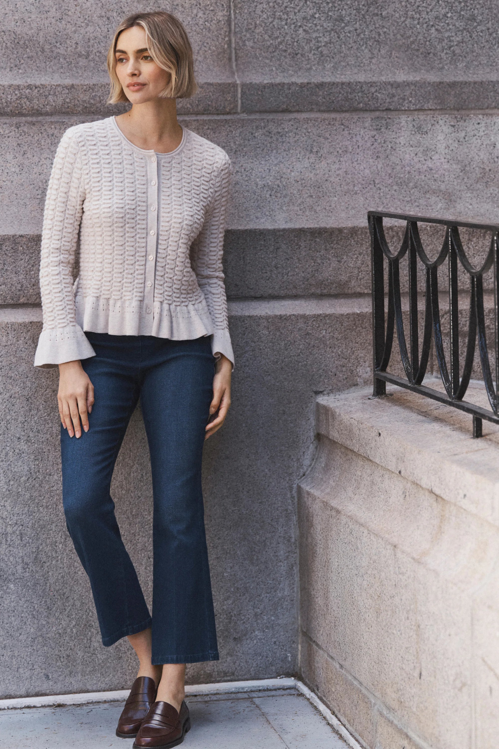 Dark indigo bootcut jeans, fitted through the thigh, with a subtle flare at the ankle.