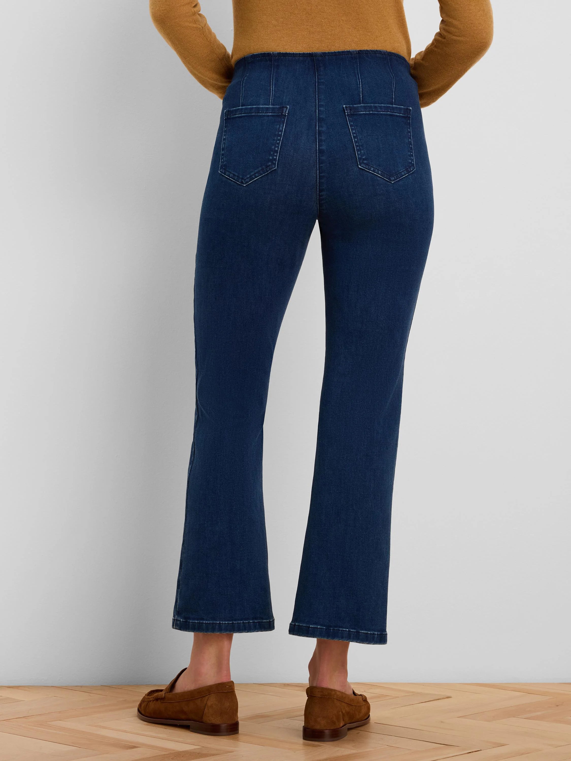 Dark blue cropped bootcut jeans with back patch pockets.