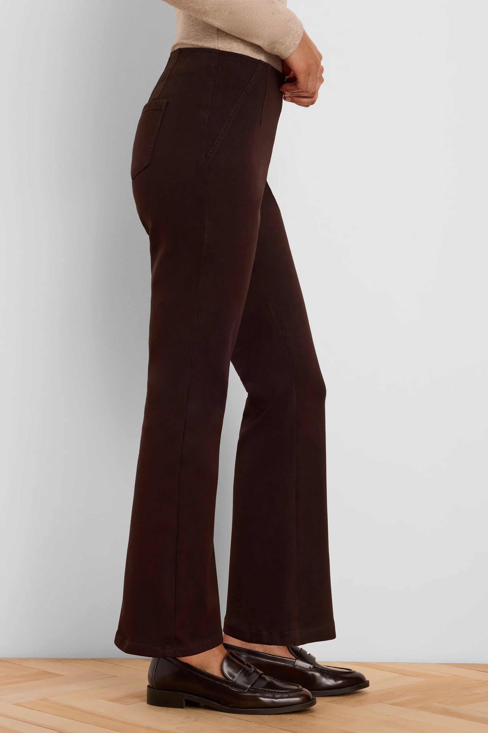 Dark brown boot-cut jeans, fitted through the thigh and flared at the ankle.