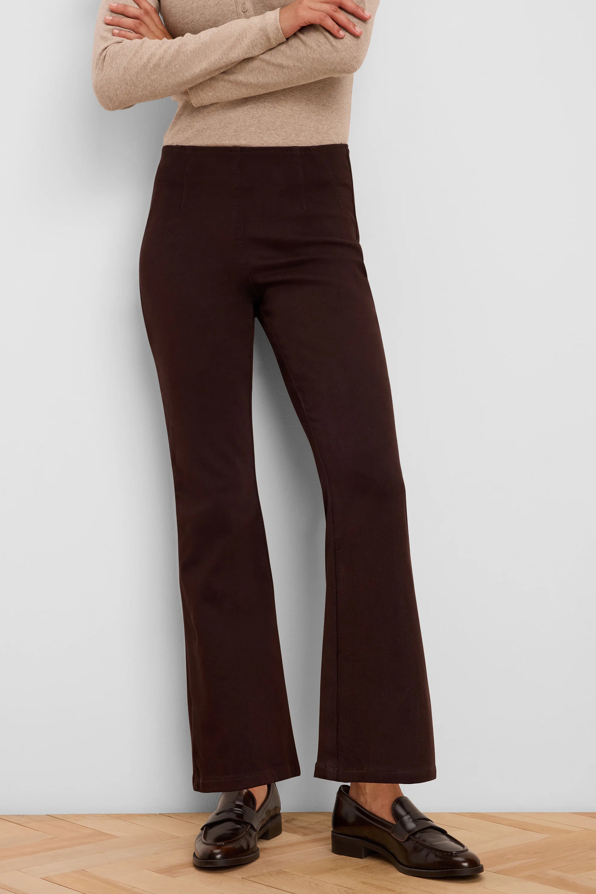 Dark brown jeans with a smooth, flat waist and subtle bootcut flare.