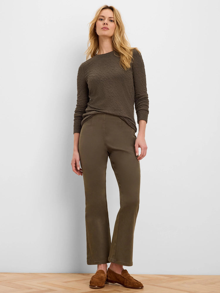 Olive green bootcut jeans, fitted through the thigh with a subtle flare, featuring a smooth, flat waistband.