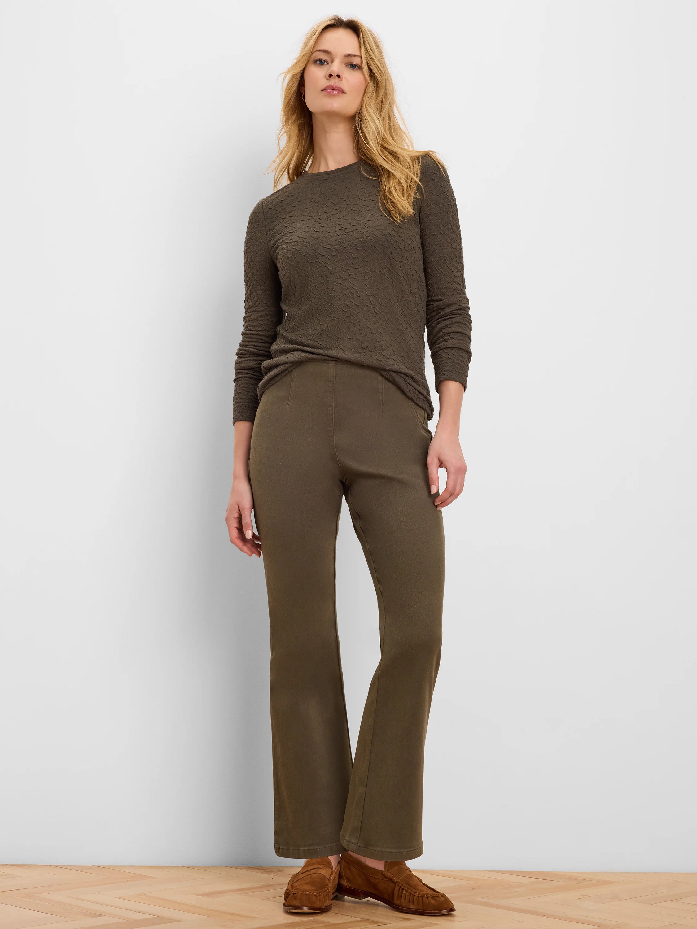 Dark olive green, full-length bootcut jeans with a subtle flare at the hem.