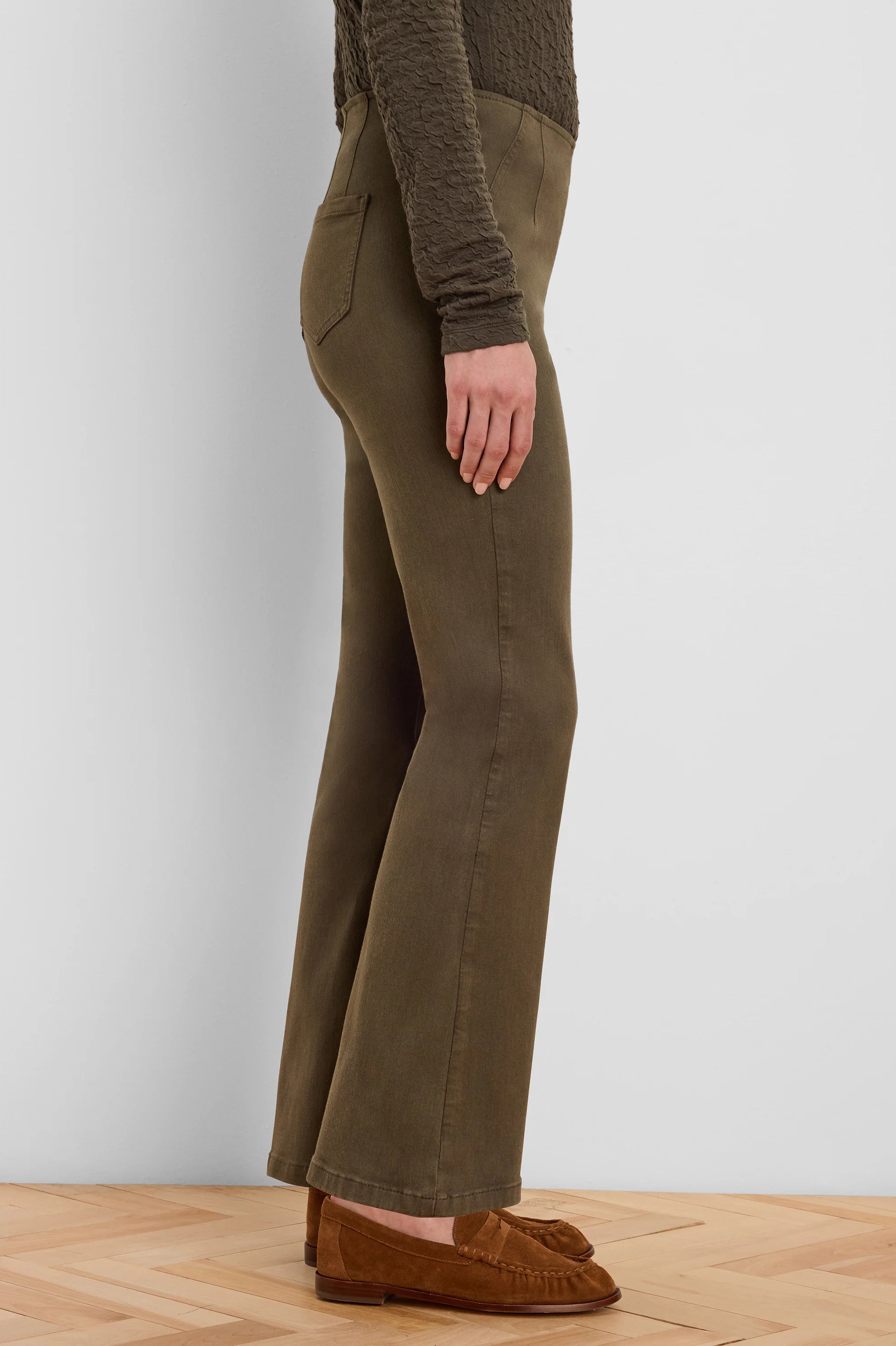 Olive green bootcut jeans, shown from the side. They have a gentle flare below the knee.