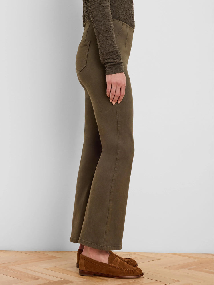 Olive green boot-cut jeans, fitted through the thigh and flaring below the knee.