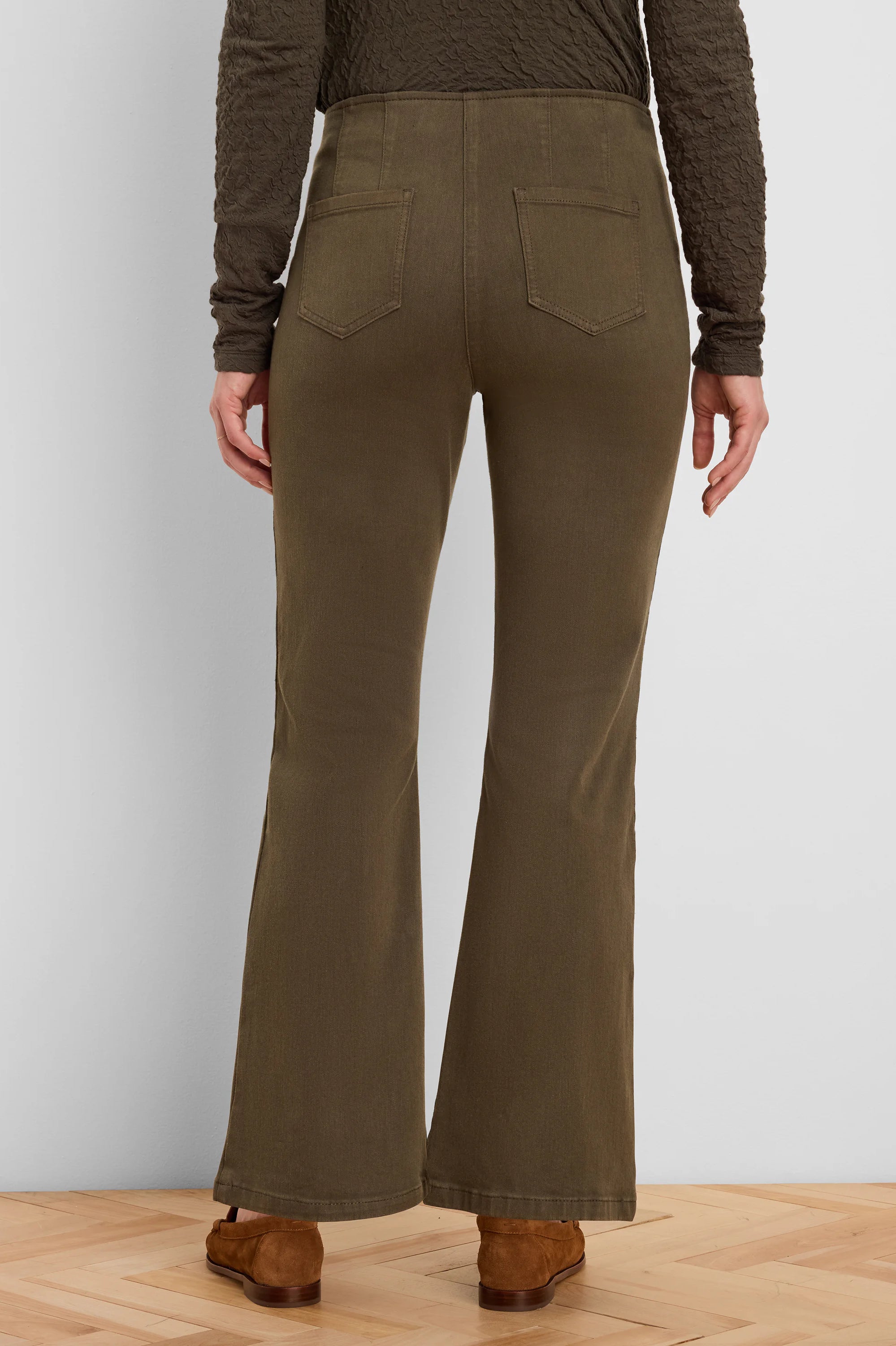 Back view of olive green high-waisted bootcut jeans with two patch pockets on the rear.