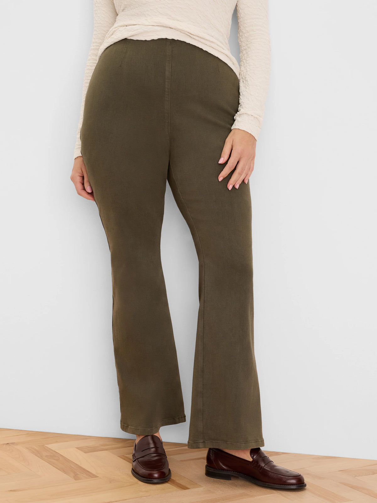 Olive bootcut jeans. High-waisted, slim through the thigh with a subtle flare.