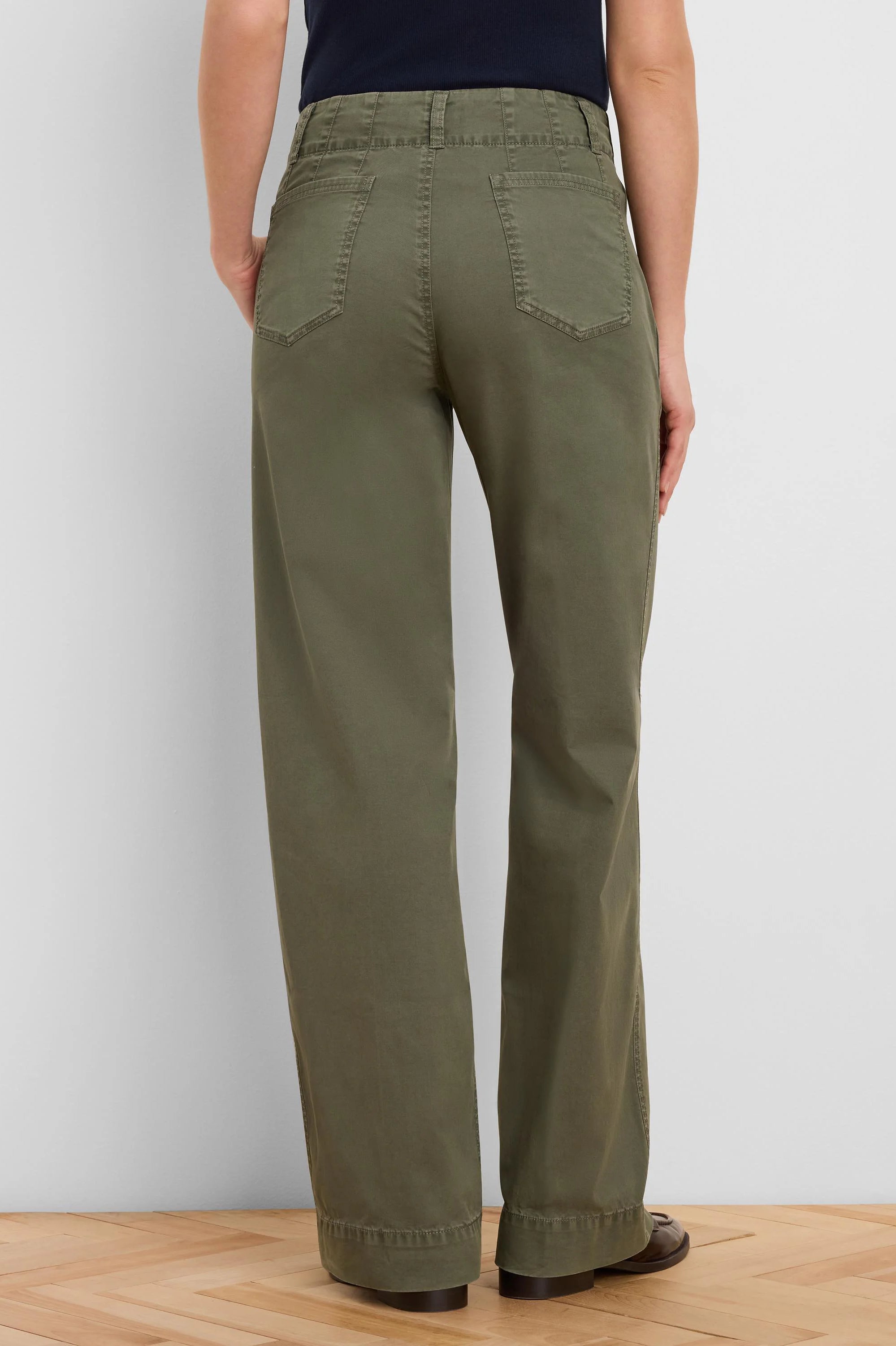 Olive green wide-leg pants, high-waisted with back pockets and belt loops, on model facing away.