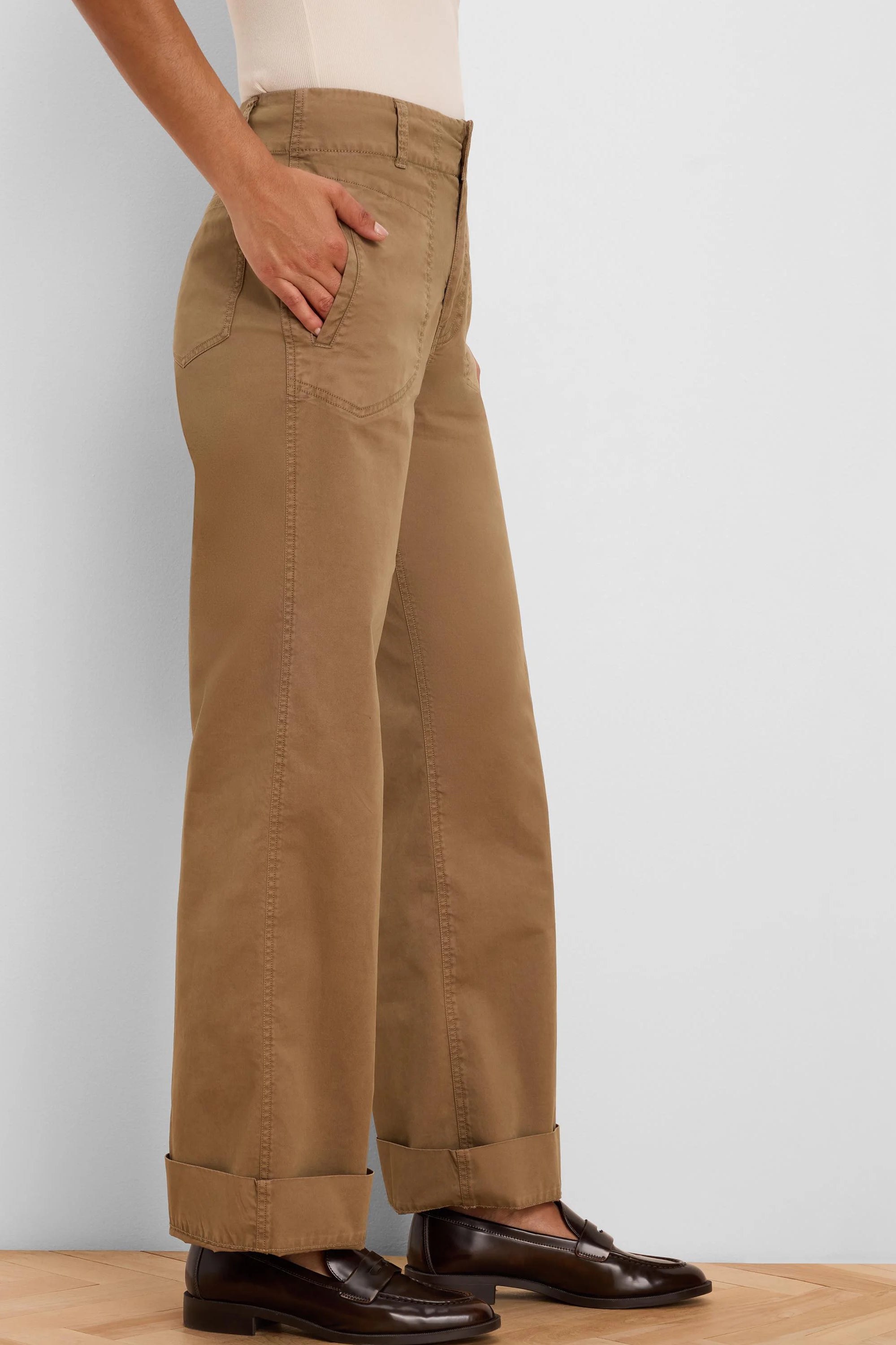 Tan wide-leg pants with angled front pockets, cuffed at the ankle.