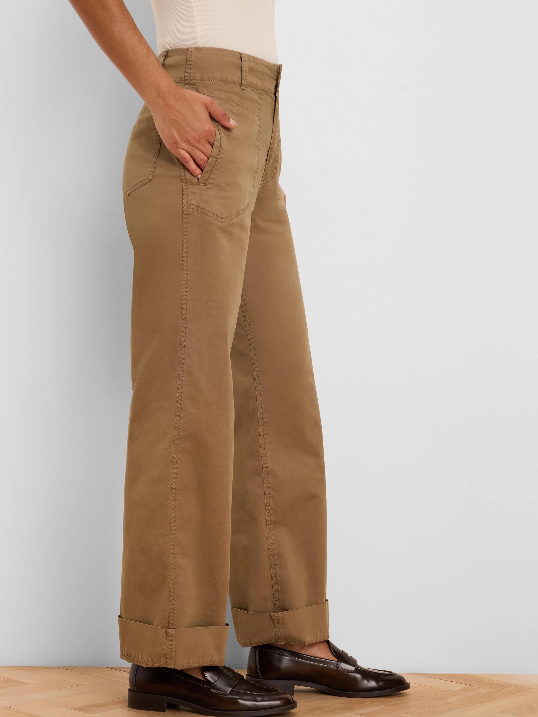 Tan wide-leg pants with angled front pockets, cuffed at the ankle.