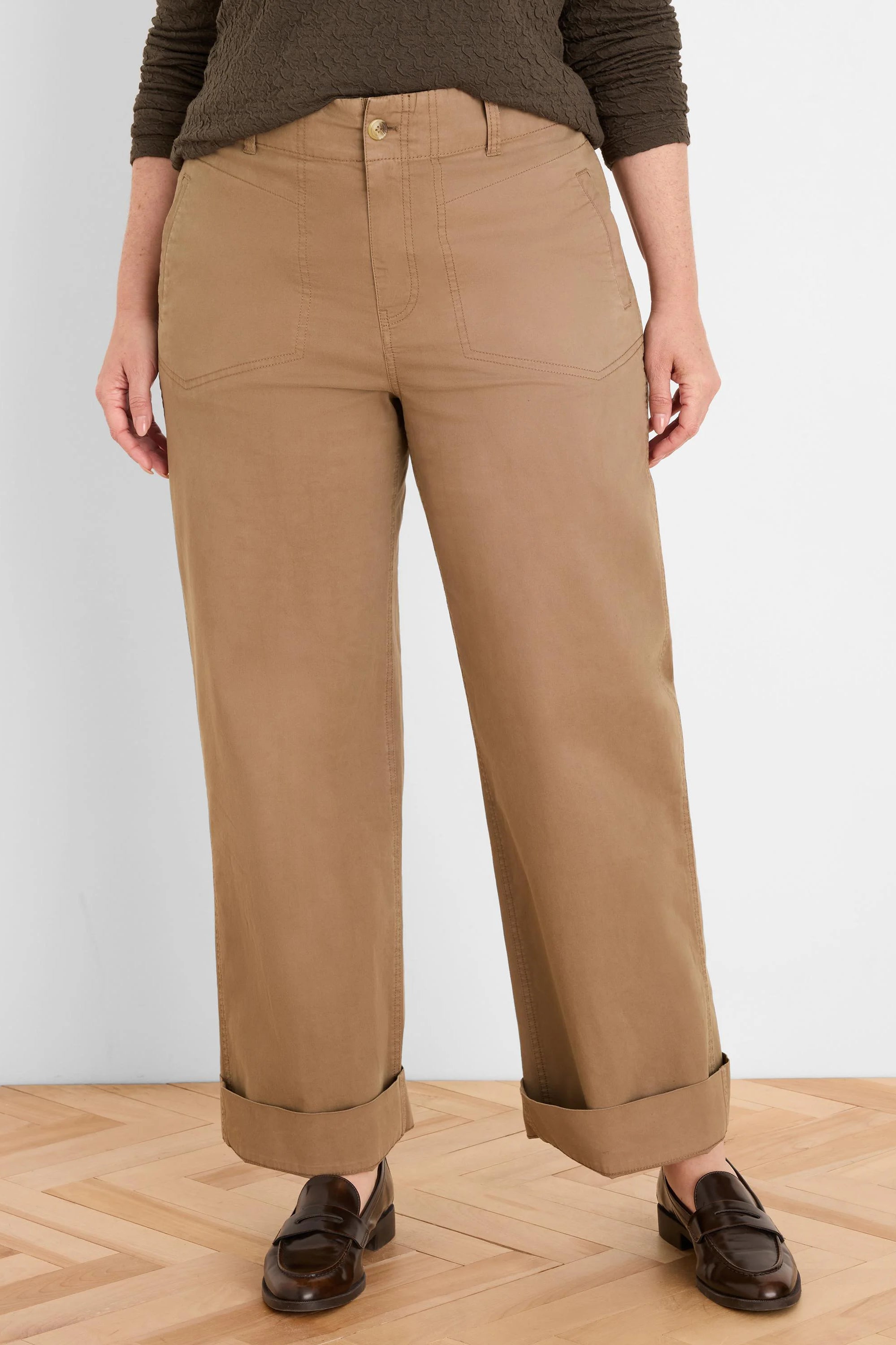 Tan wide-leg pants with cuffed hems, angled front pockets, and a button closure.