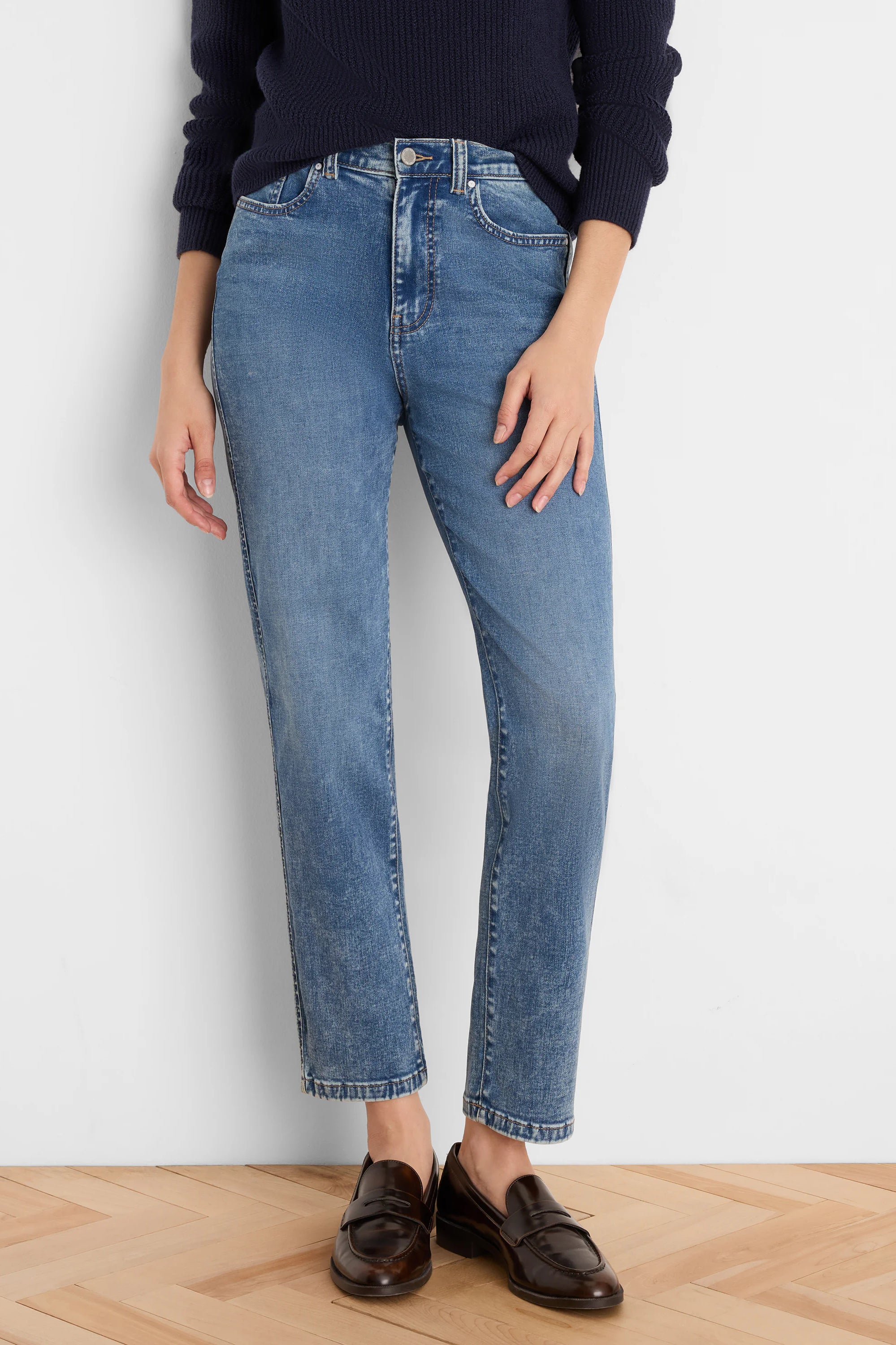 Medium blue straight leg jeans with a faded wash, high waist, and slightly cropped length.