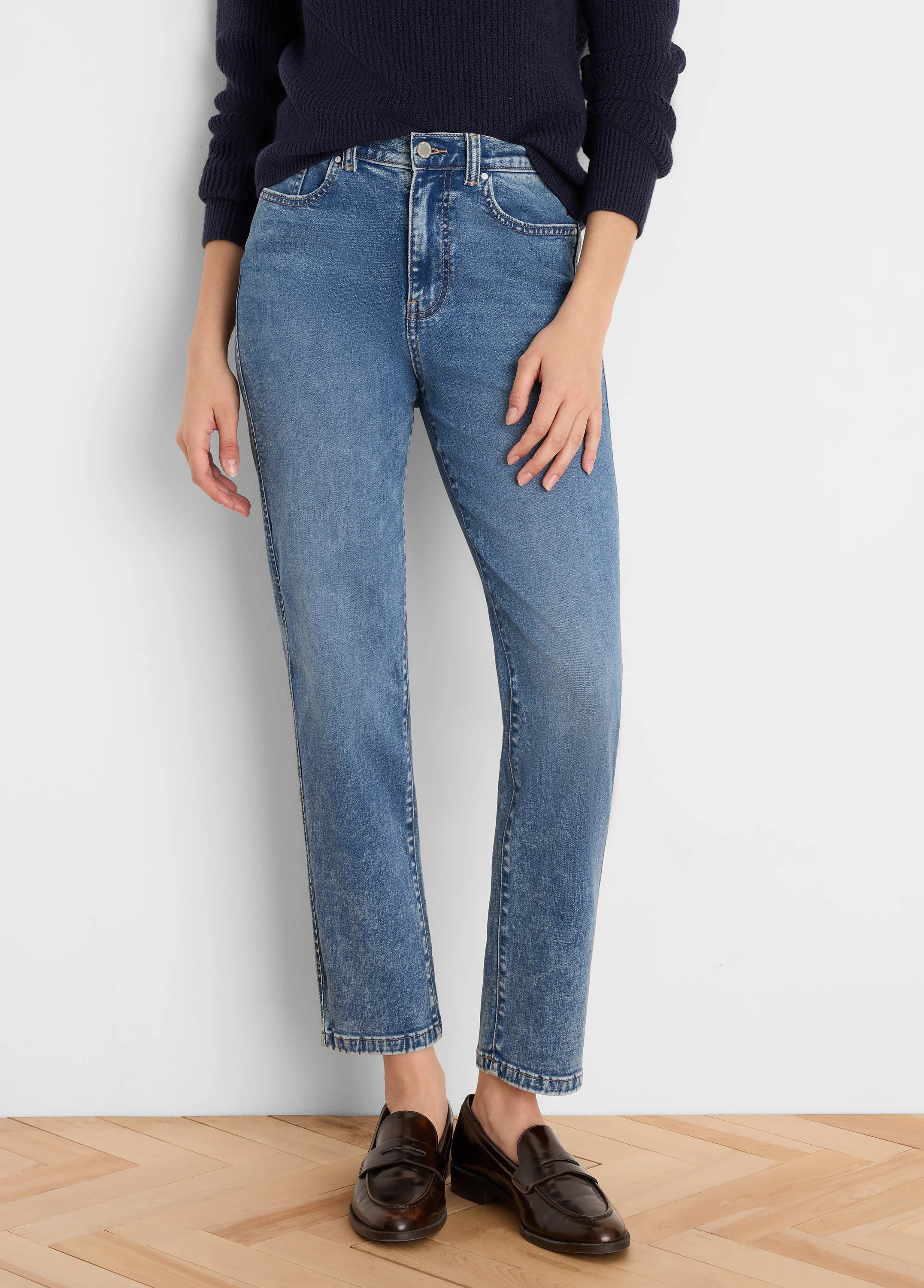 Medium blue straight leg jeans with a faded wash, high waist, and slightly cropped length.