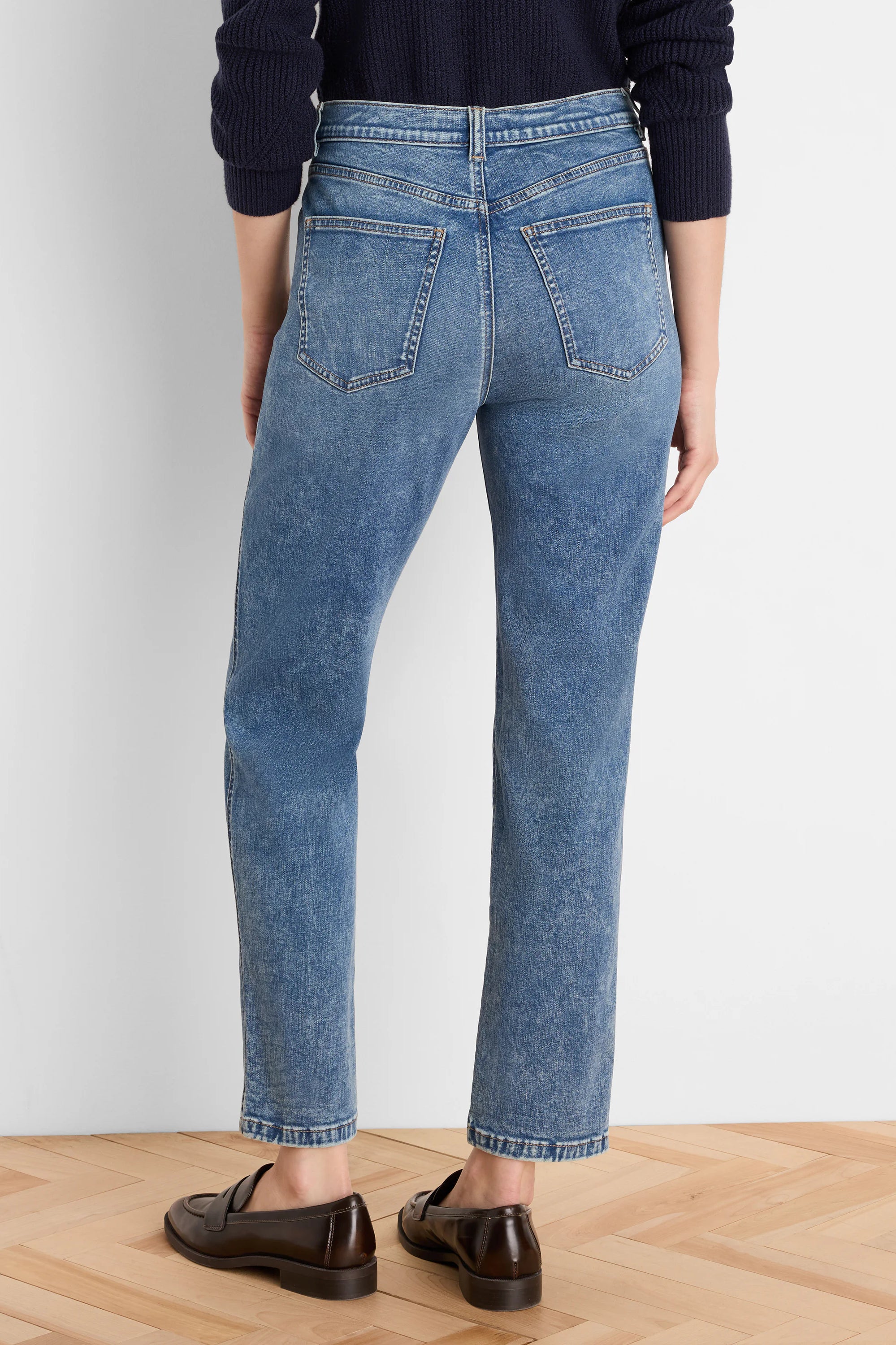 Medium blue, vintage wash straight leg jeans shown from the back, featuring classic back pockets and an ankle-length hem.