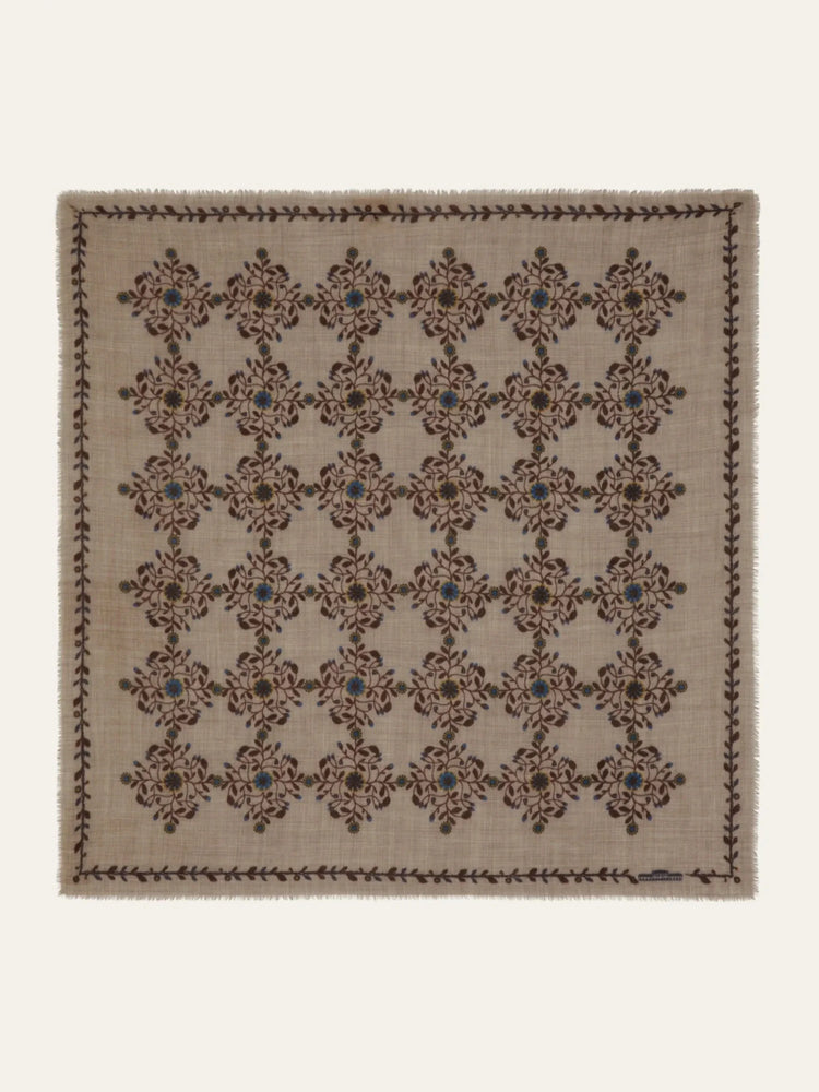 Beige square scarf with brown and blue floral pattern; dark brown and green border.