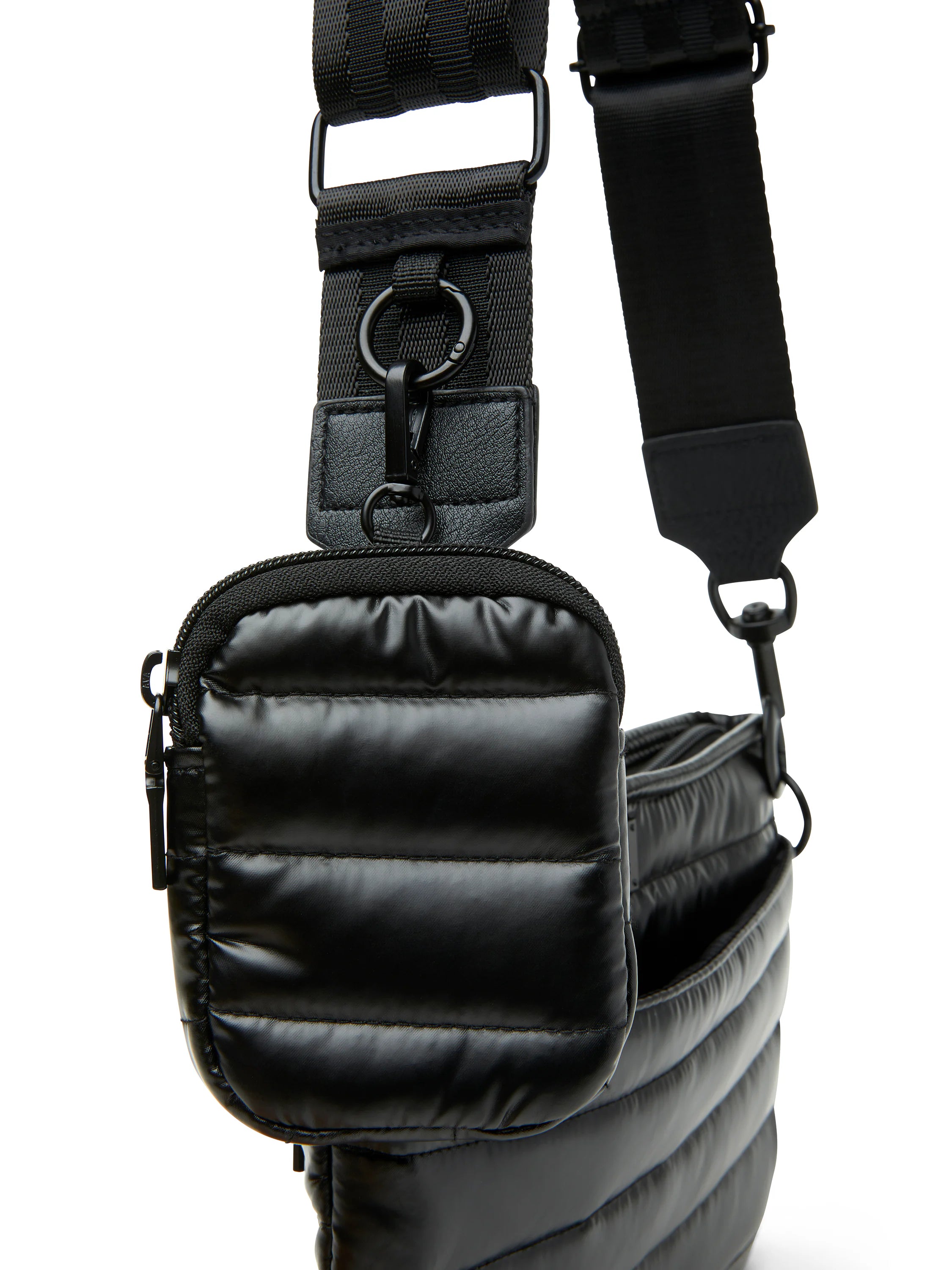 Black quilted crossbody bag with black adjustable strap and hardware. Small zippered front pocket.