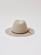 Beige felt fedora with a brown suede band and tie.