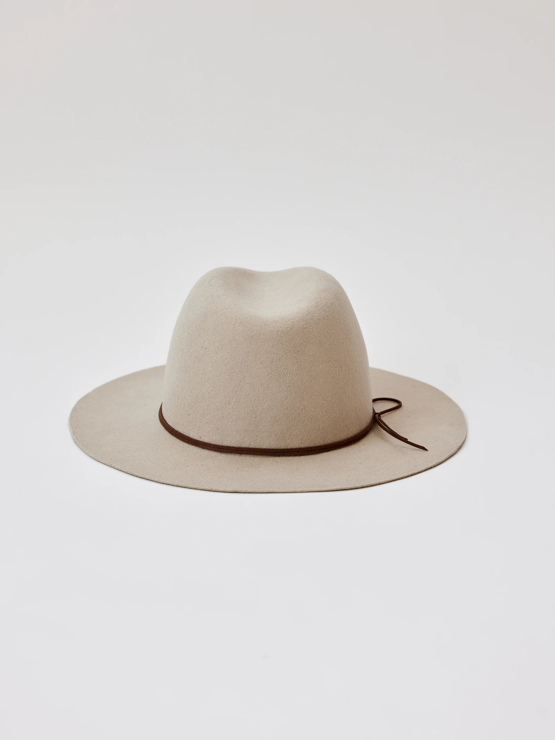 Beige felt fedora with a brown suede band and tie.