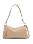 Pale beige pebbled leather shoulder bag with silver stud details on sides and a slender strap connected by rings.